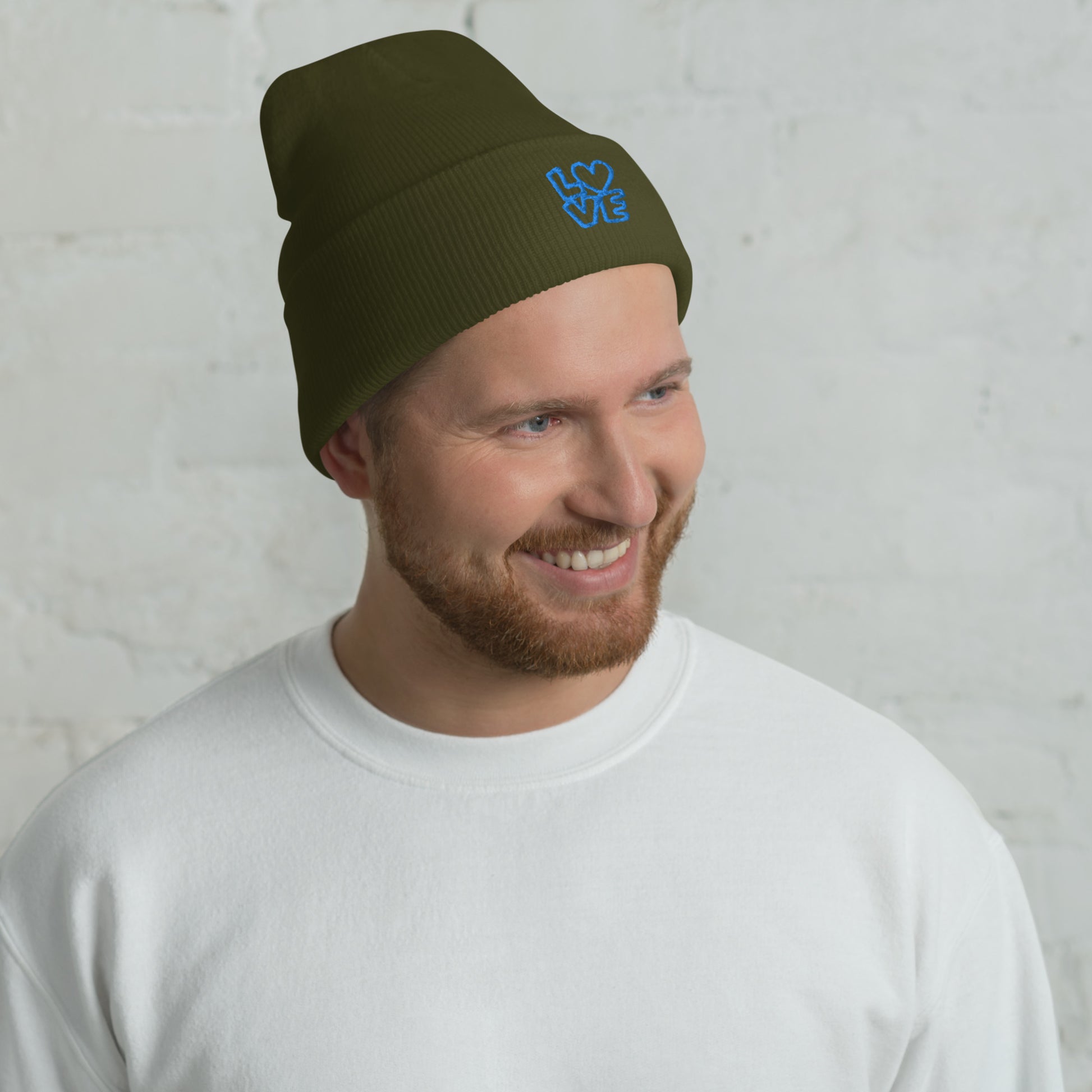 Men with olive beanie with the blue letters LOVE with the O in heart shape