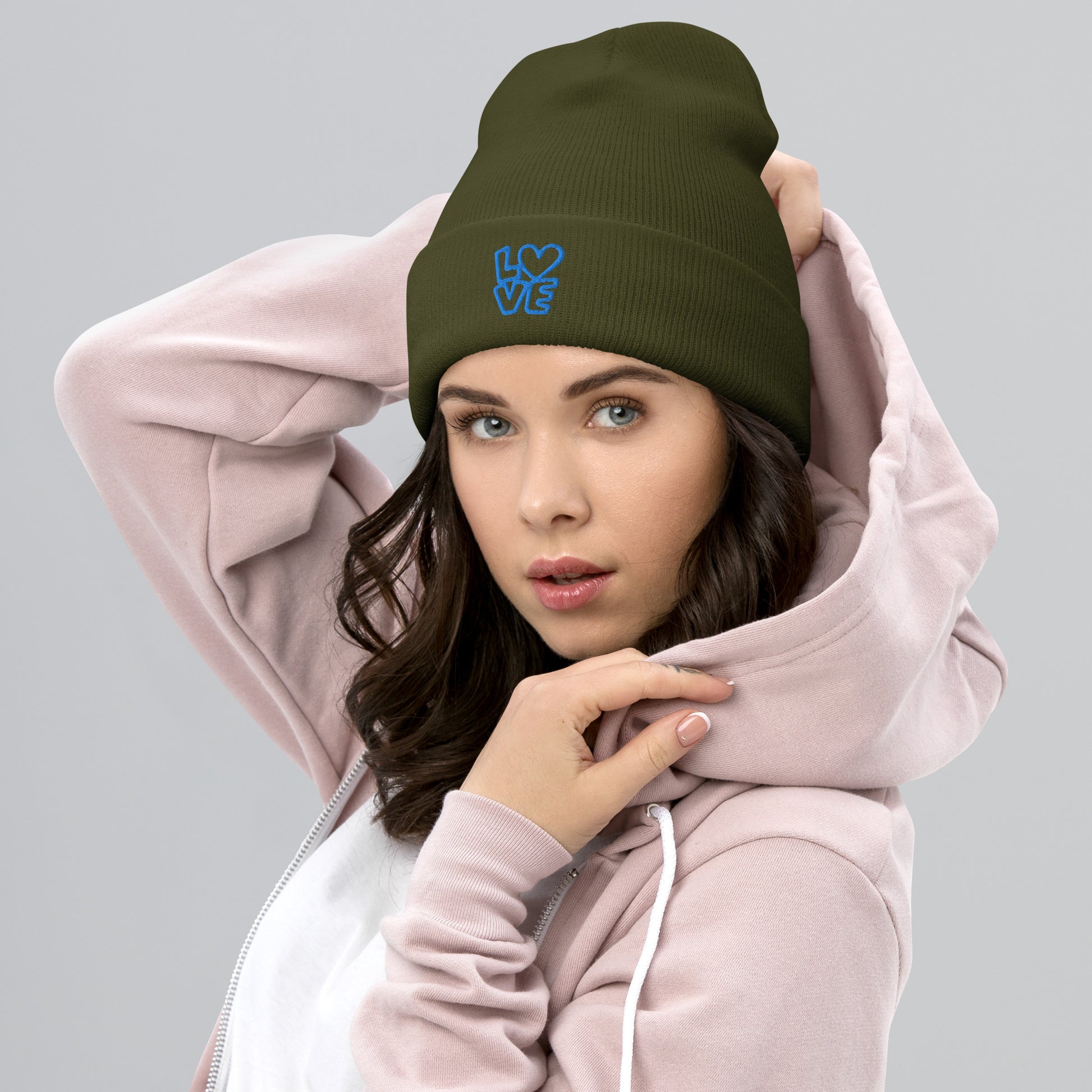 Women with olive beanie with the blue letters LOVE with the O in heart shape