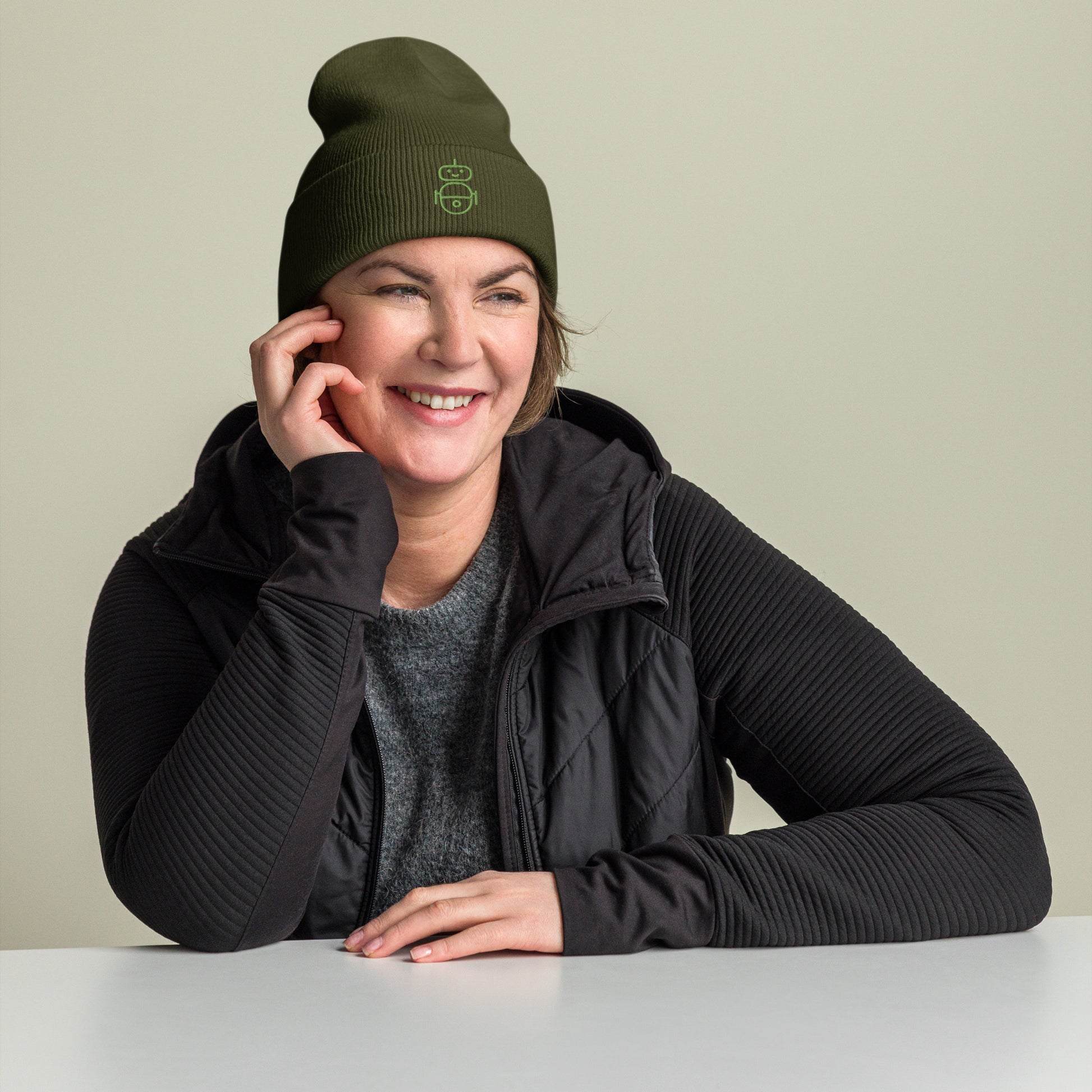 Women with olive beanie and Android logo in green