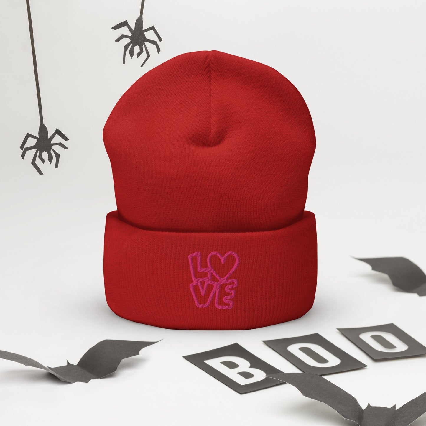 Red beanie with the pink letters LOVE with the O in heart shape