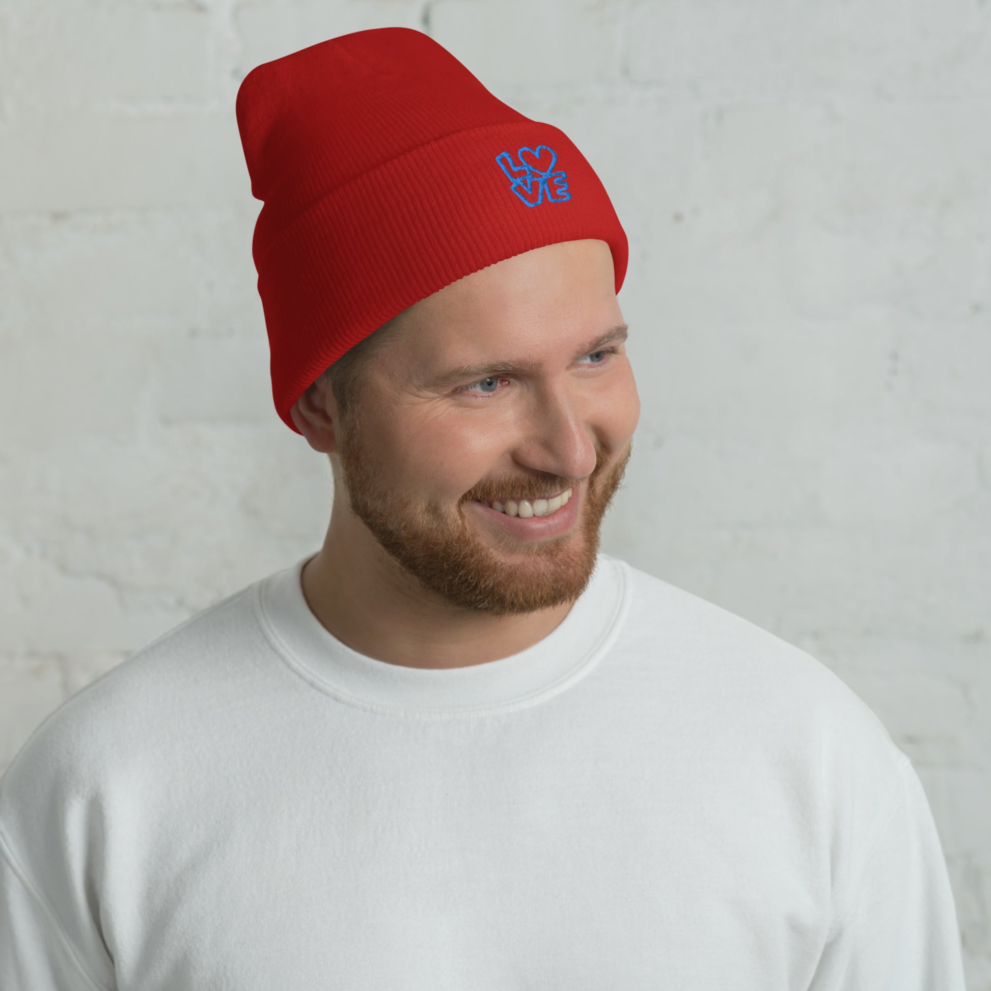 Men with red beanie with the blue letters LOVE with the O in heart shape