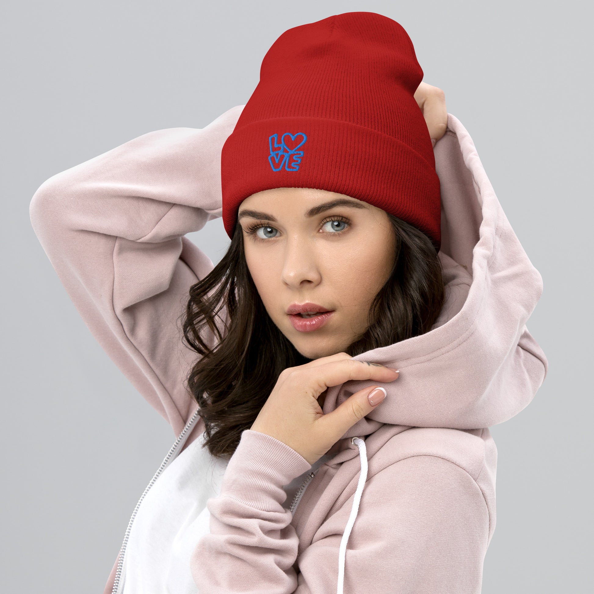 Women with red beanie with the blue letters LOVE with the O in heart shape
