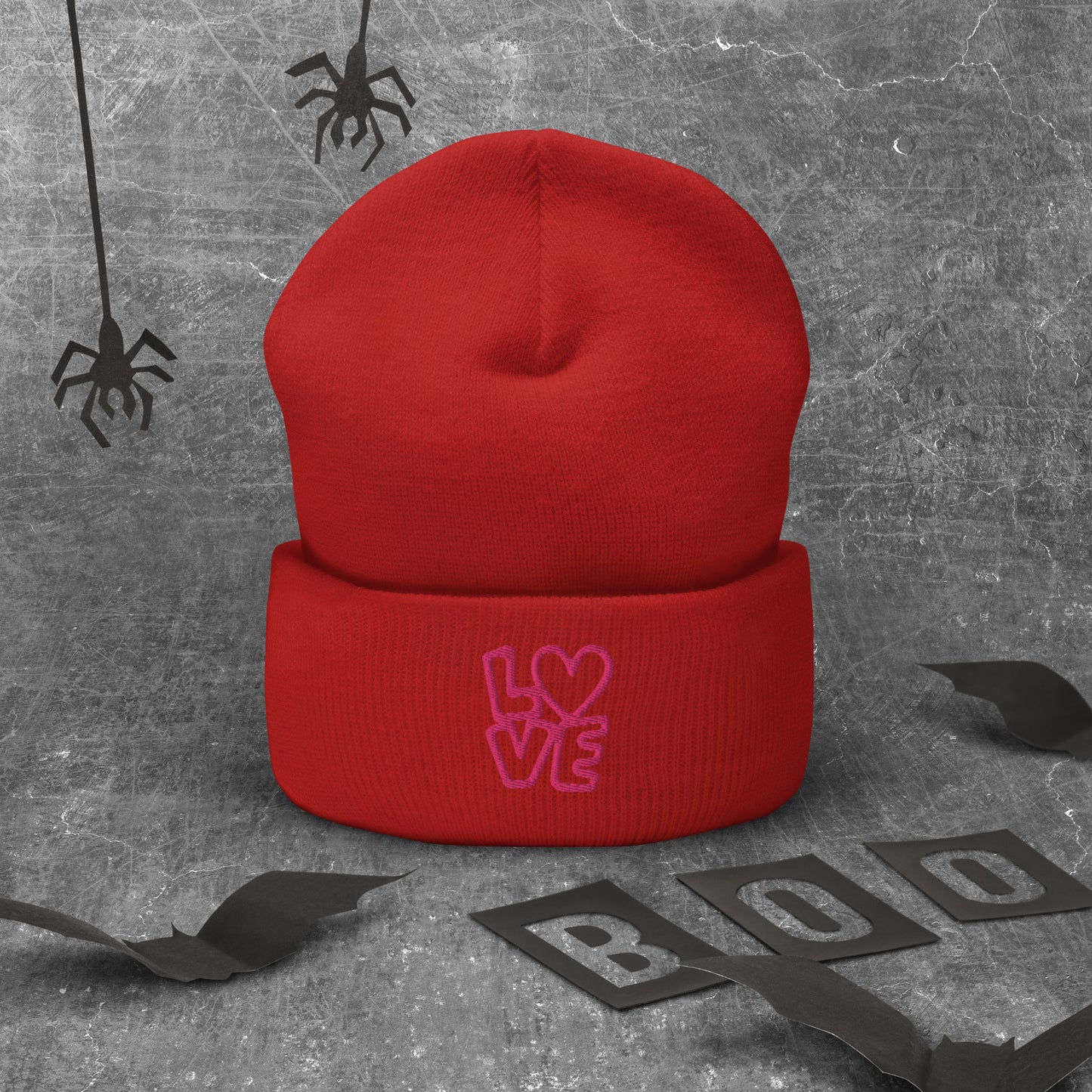 Red beanie with the pink letters LOVE with the O in heart shape