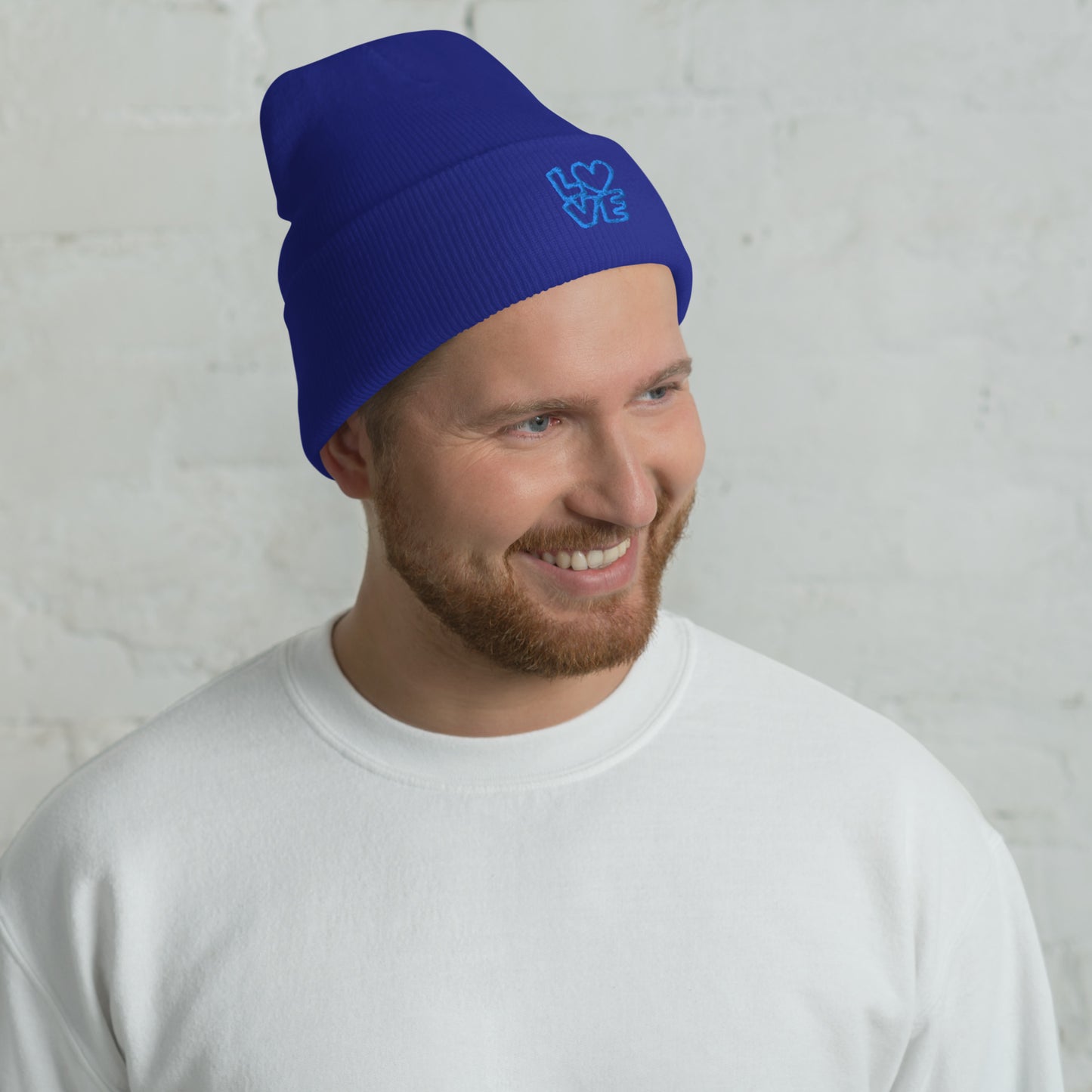 Men with royal blue beanie with the blue letters LOVE with the O in heart shape
