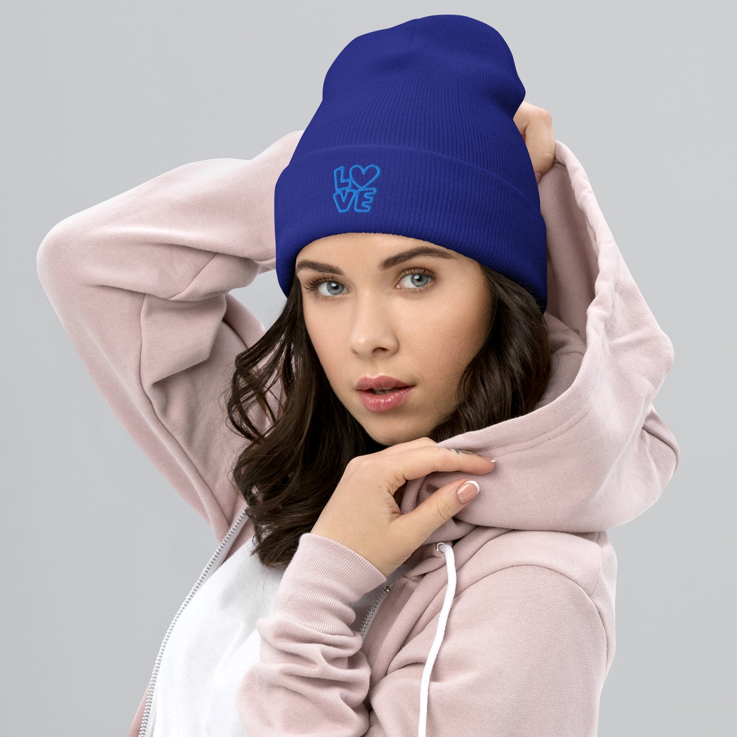 Women with royal blue beanie with the blue letters LOVE with the O in heart shape