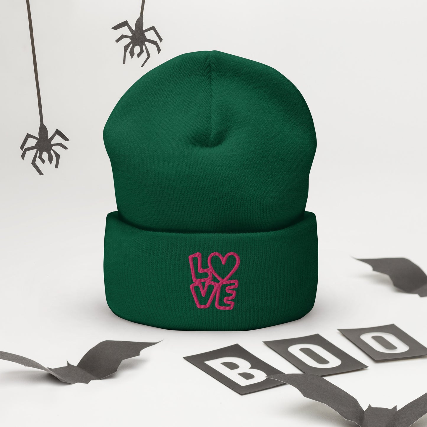 Green beanie with the pink letters LOVE with the O in heart shape