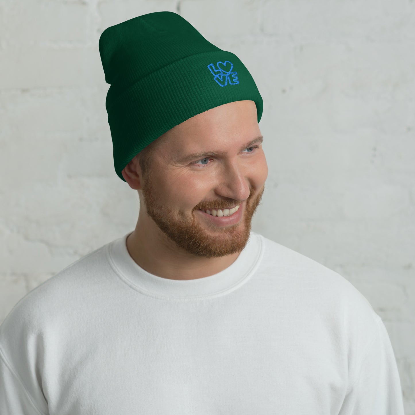 Men with green beanie with the blue letters LOVE with the O in heart shape