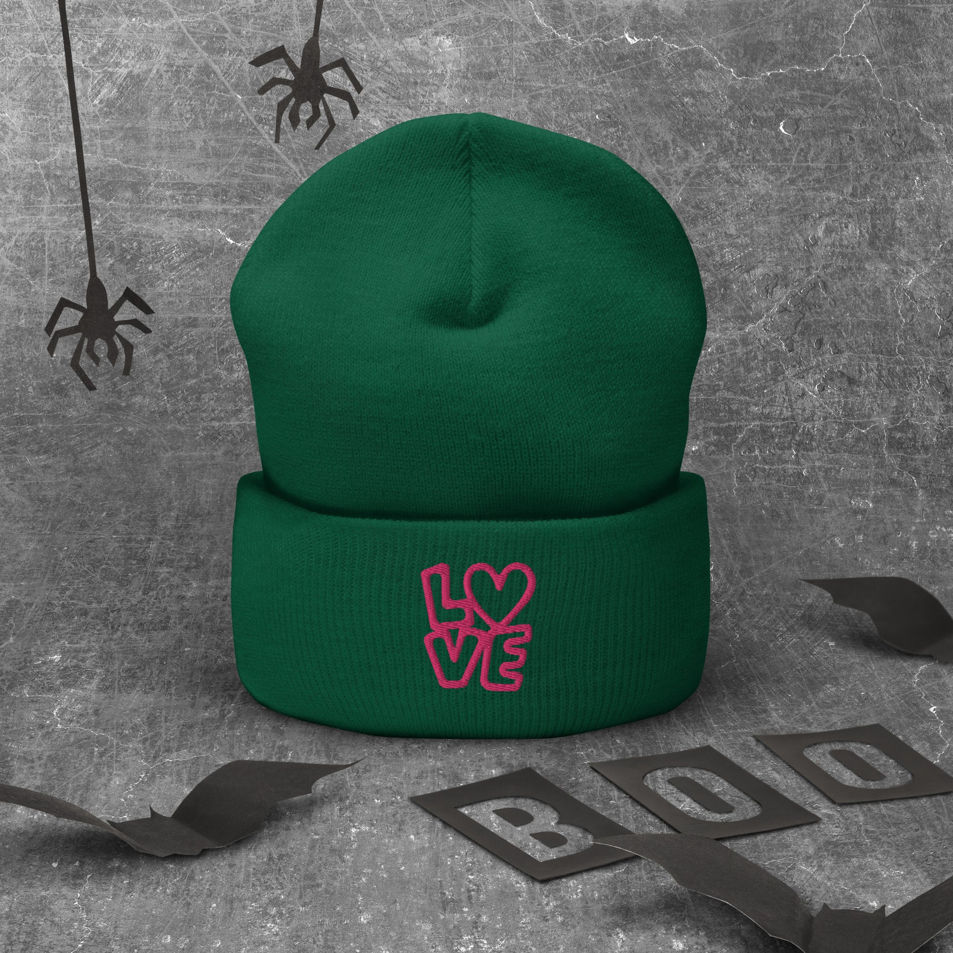 Green beanie with the pink letters LOVE with the O in heart shape