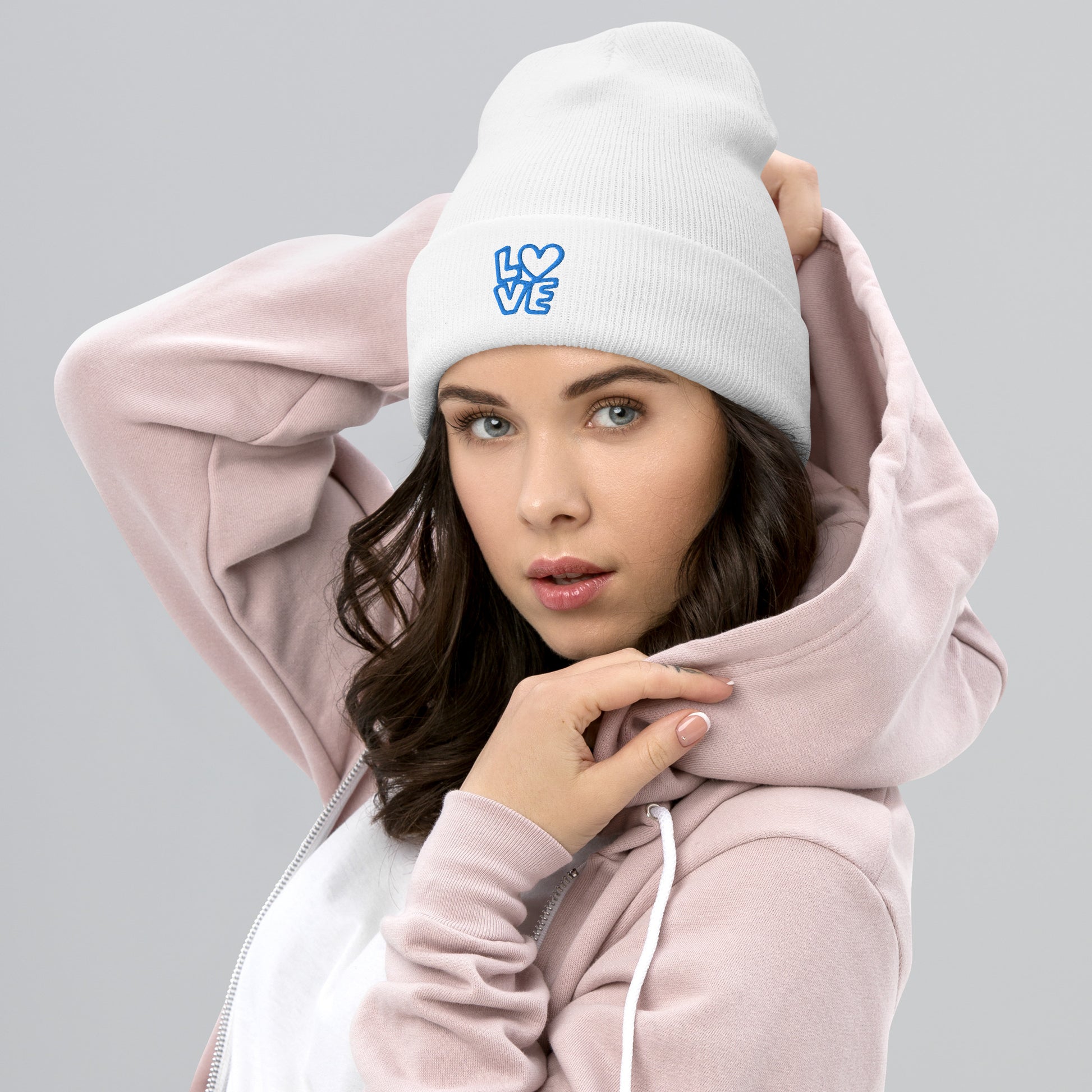 Women with white beanie with the blue letters LOVE with the O in heart shape