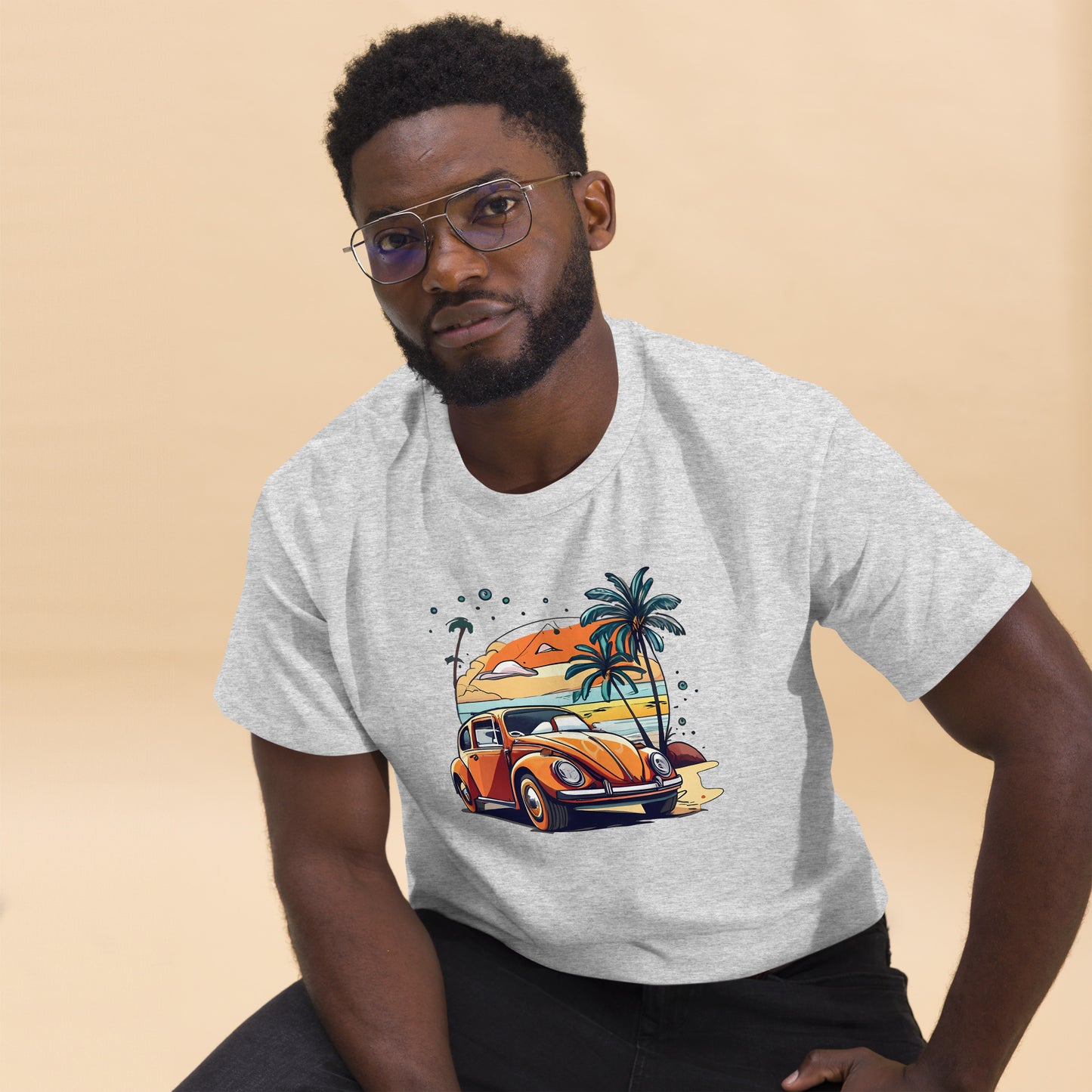 man with grey t-shirt with picture of beetle car in front of palm trees