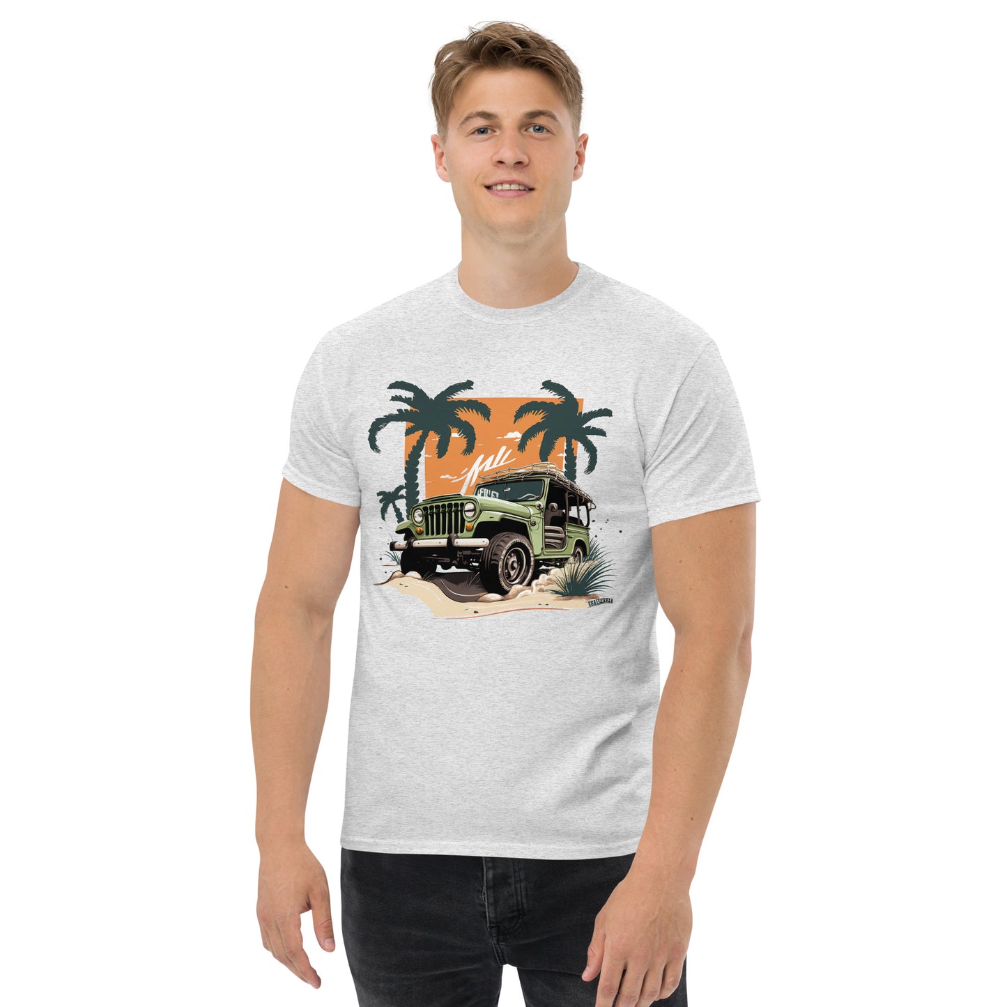 man with grey t-shirt with picture of jeep in front of palm trees 