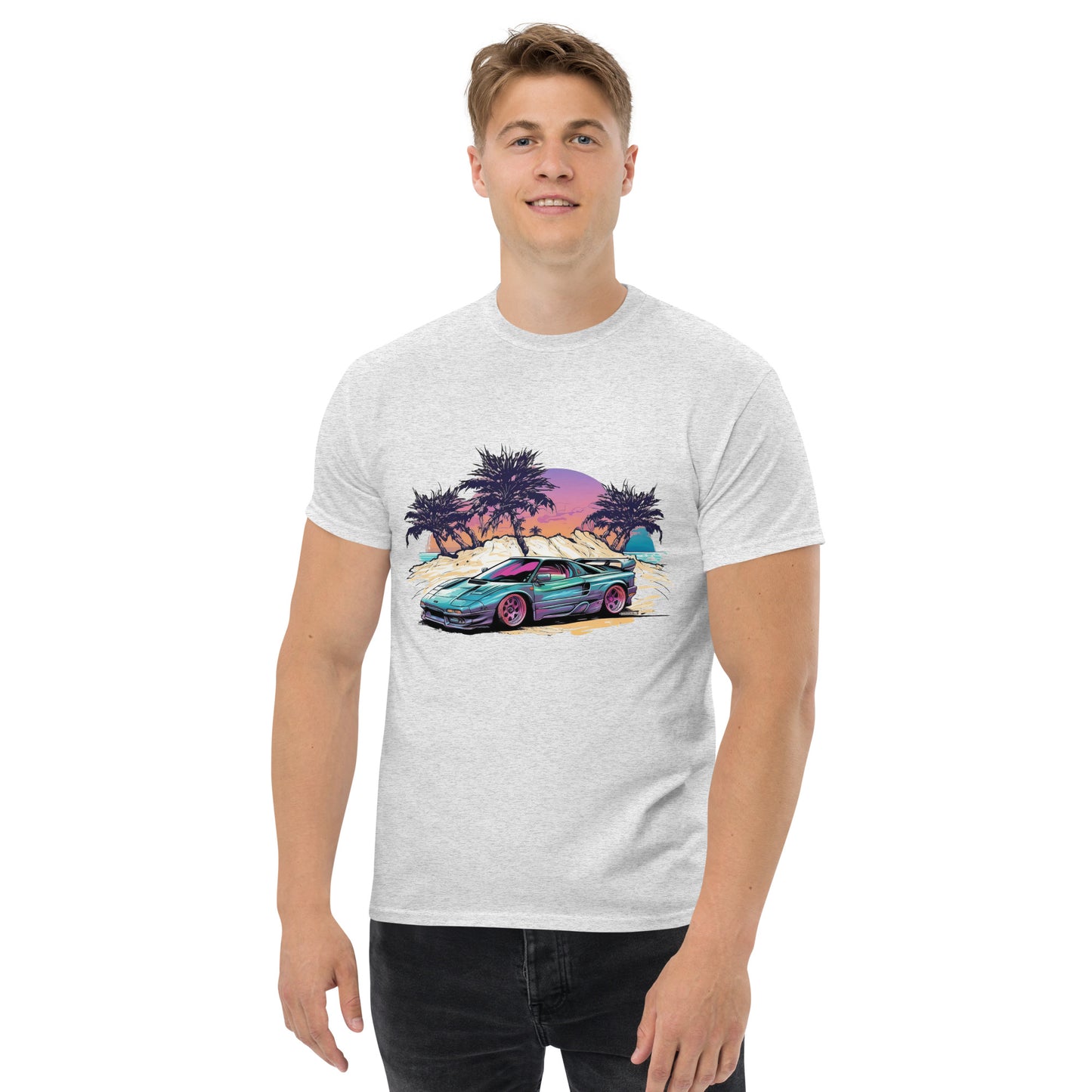 man with grey t-shirt with picture of vintage car in front of palm trees