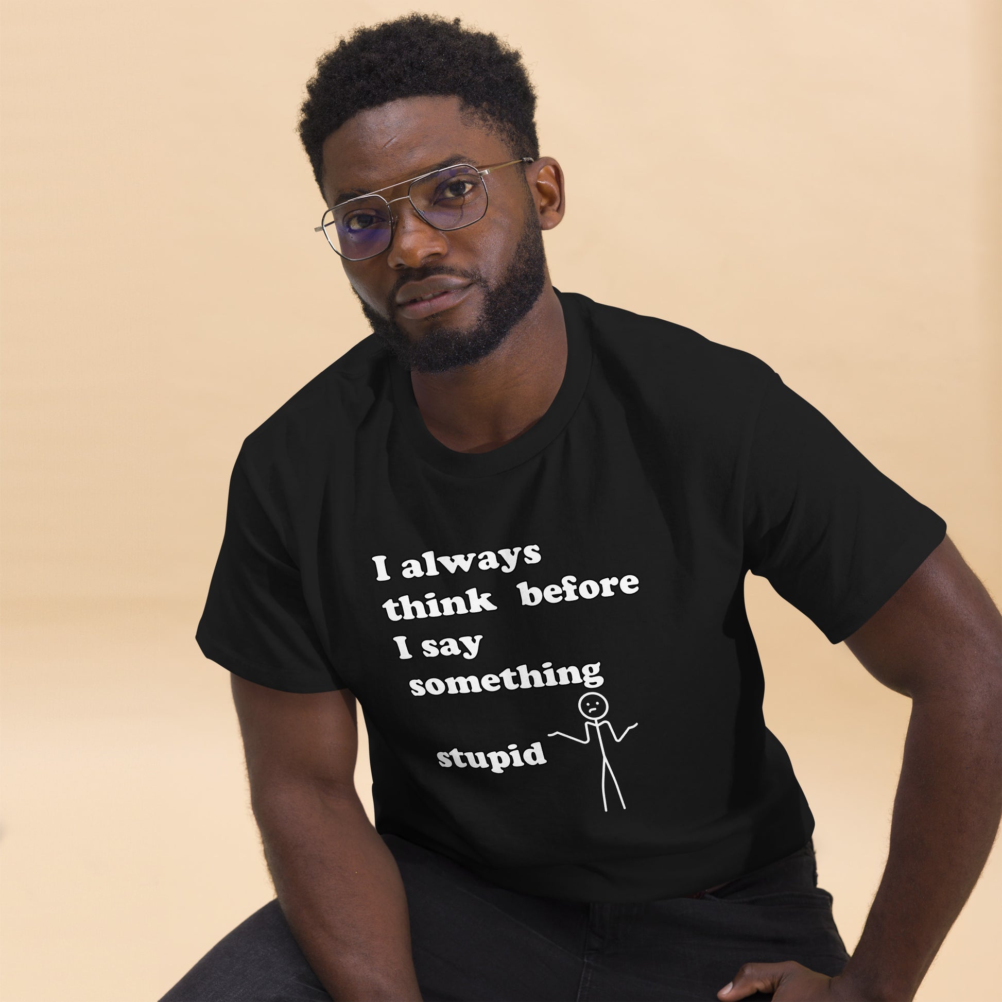 Man with black t-shirt with text "I always think before I say something stupid"