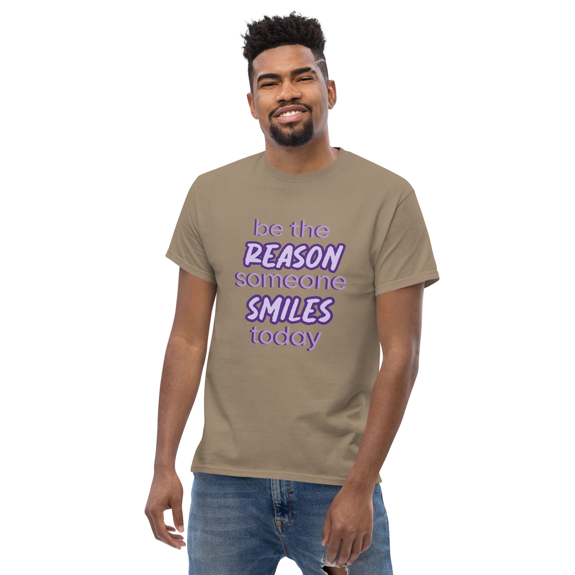 Men with brown savana T-shirt and the quote "be the reason someone smiles today" in purple on it. 