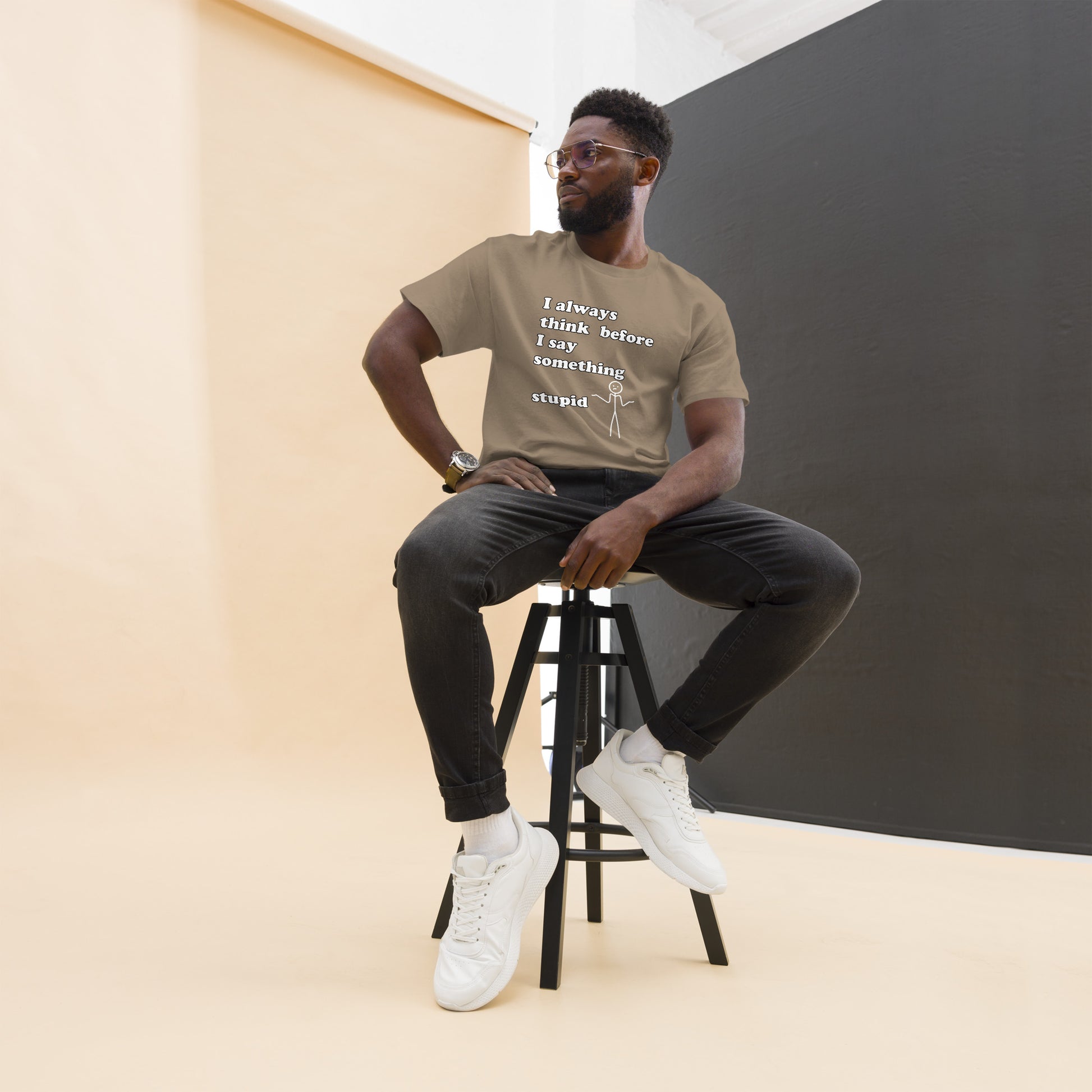 Man with brown t-shirt with text "I always think before I say something stupid"