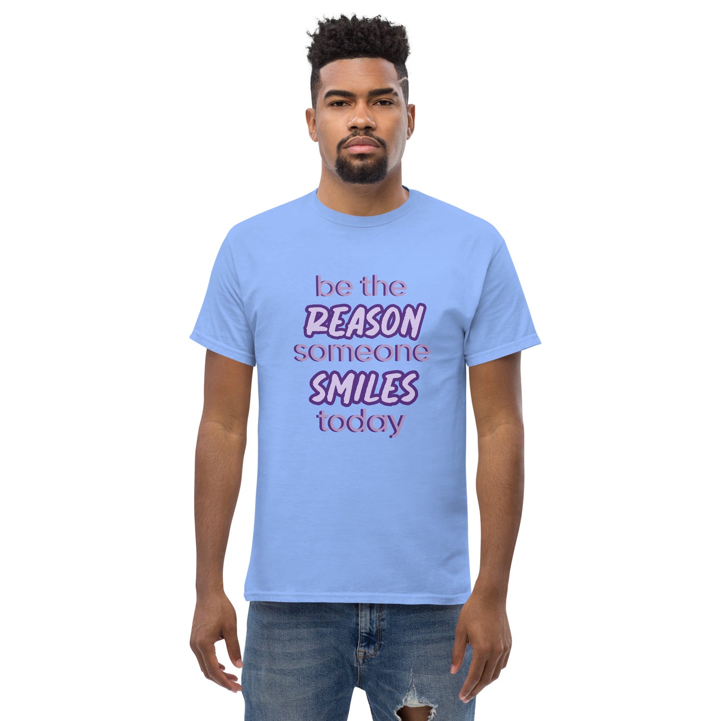 Men with carolina blue T-shirt and the quote "be the reason someone smiles today" in purple on it.