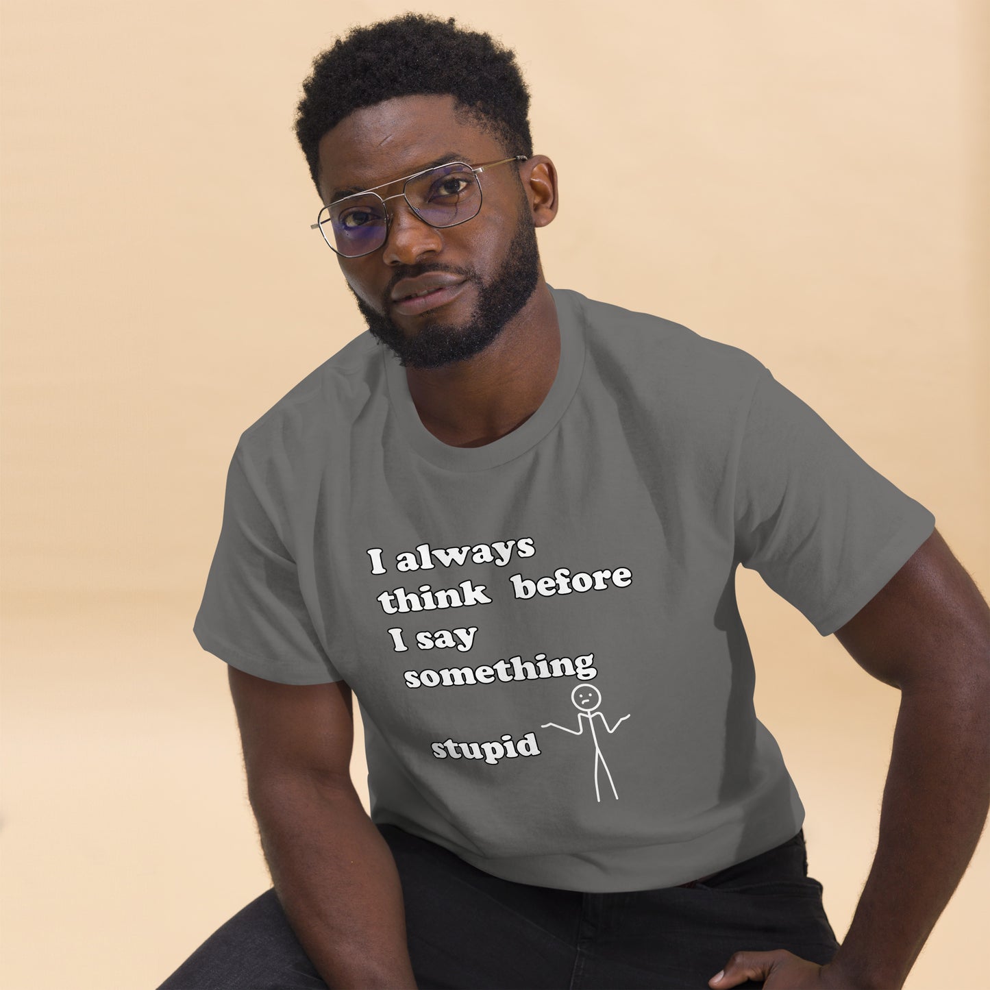 Man with grey t-shirt with text "I always think before I say something stupid"