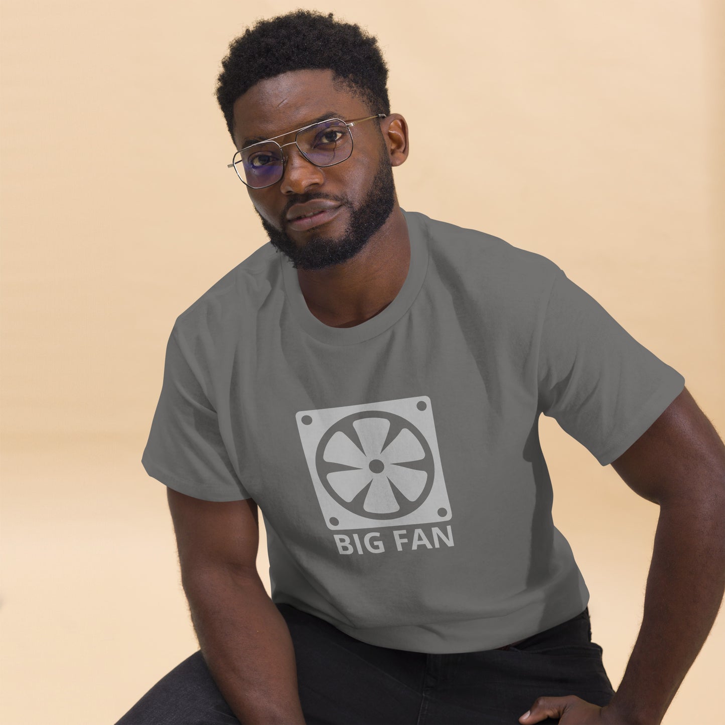 Man with charcoal t-shirt with image of a big computer fan and the text "BIG FAN"