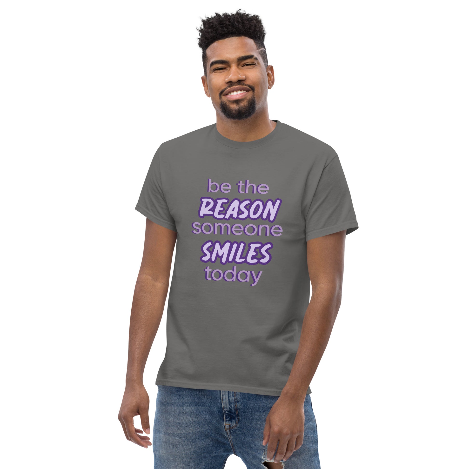 Men with charcoal T-shirt and the quote "be the reason someone smiles today" in purple on it. 
