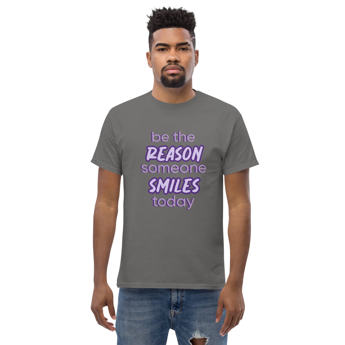 Men with charcoal T-shirt and the quote "be the reason someone smiles today" in purple on it.