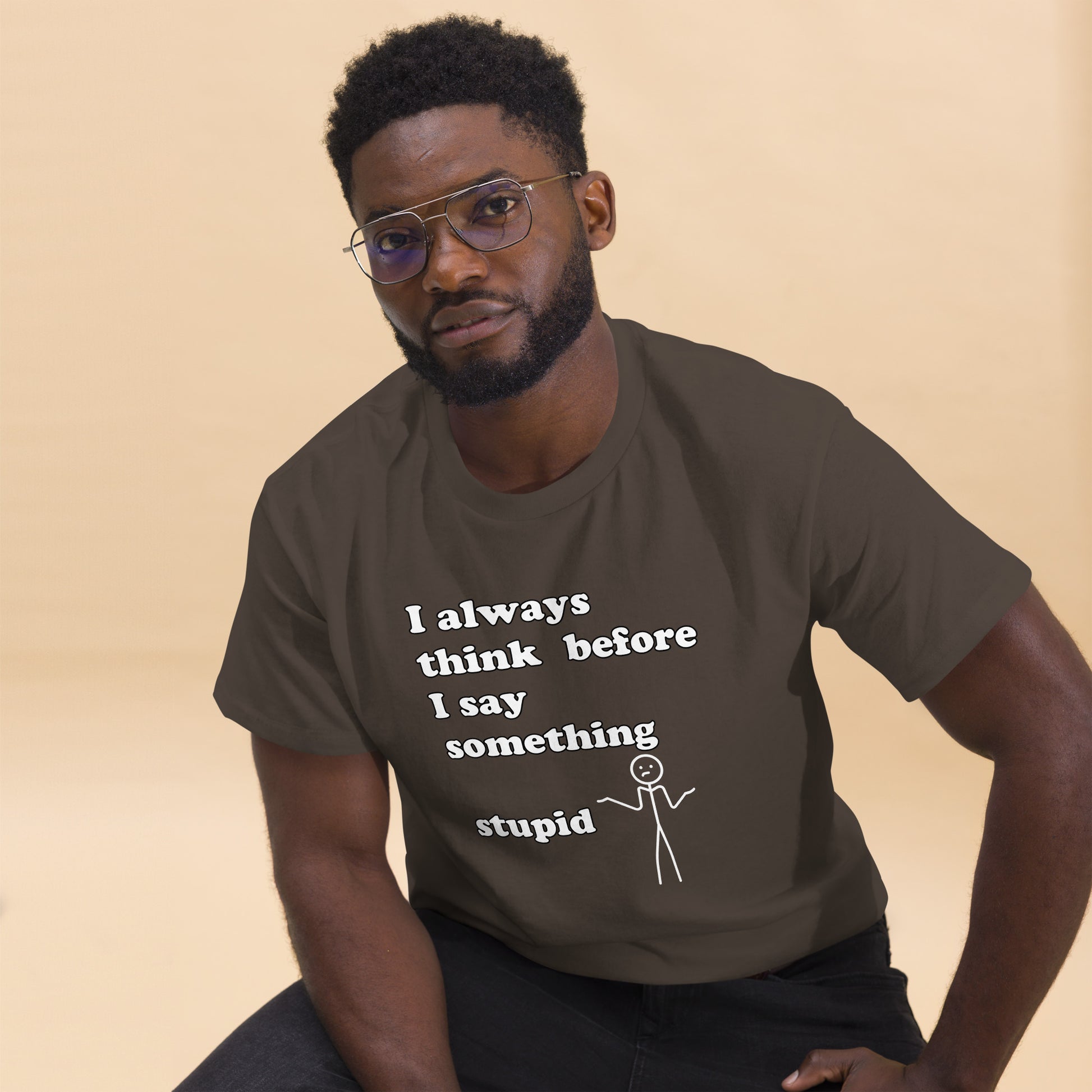 Man with brown t-shirt with text "I always think before I say something stupid"