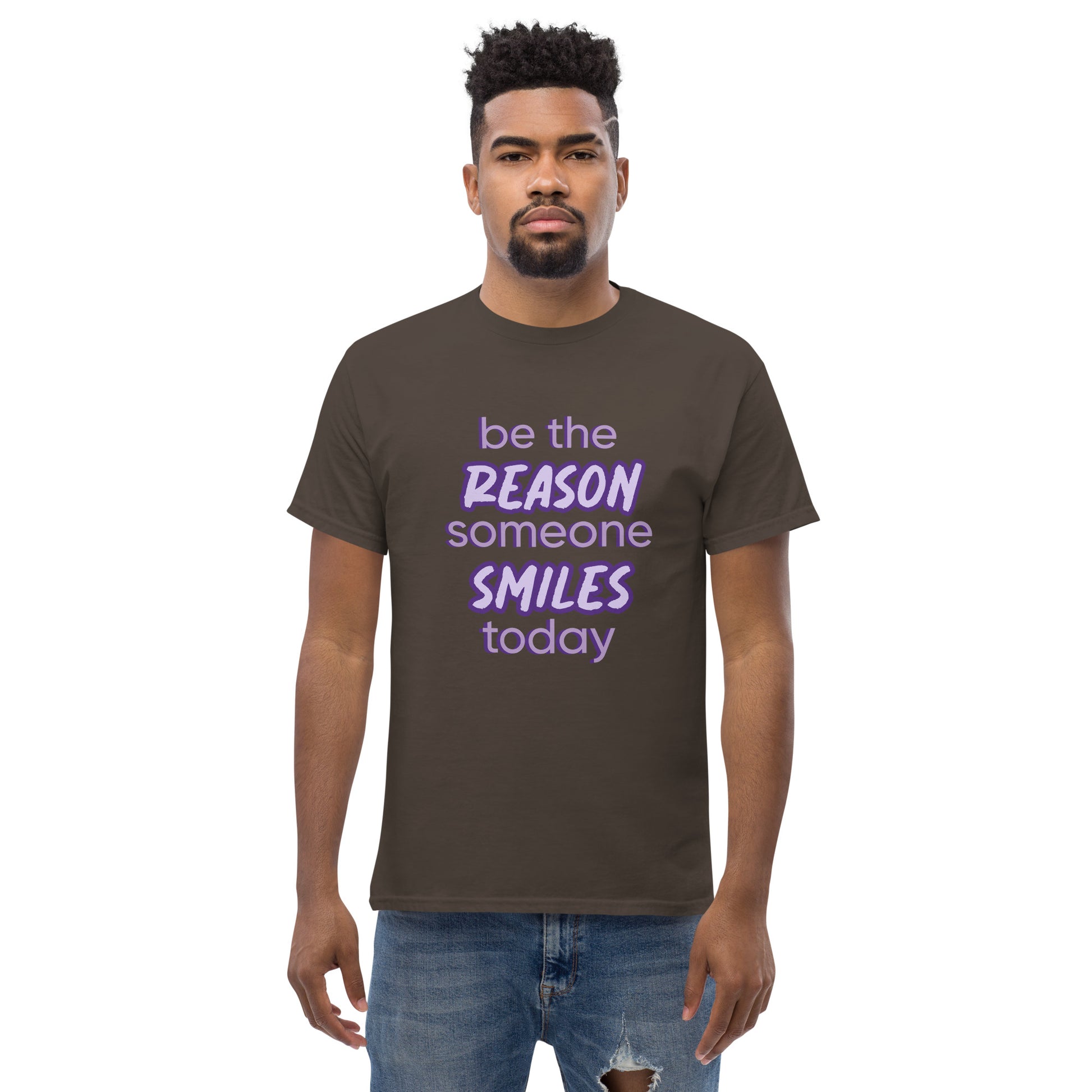Men with dark chocolate T-shirt and the quote "be the reason someone smiles today" in purple on it. 