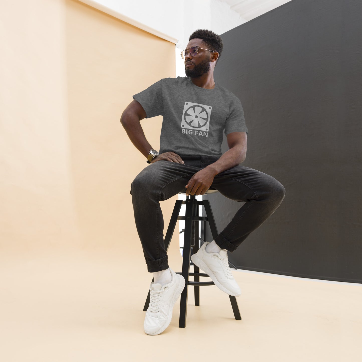 Man with dark grey t-shirt with image of a big computer fan and the text "BIG FAN"