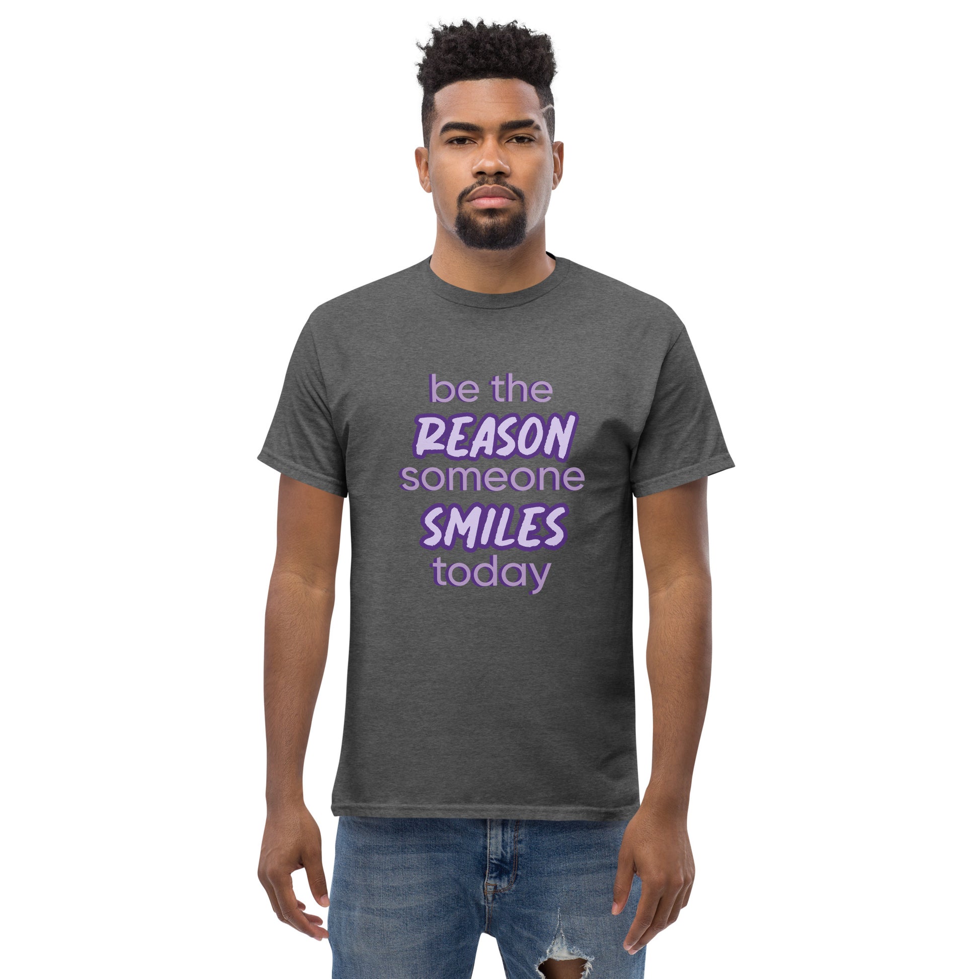 Men with dark grey T-shirt and the quote "be the reason someone smiles today" in purple on it. 