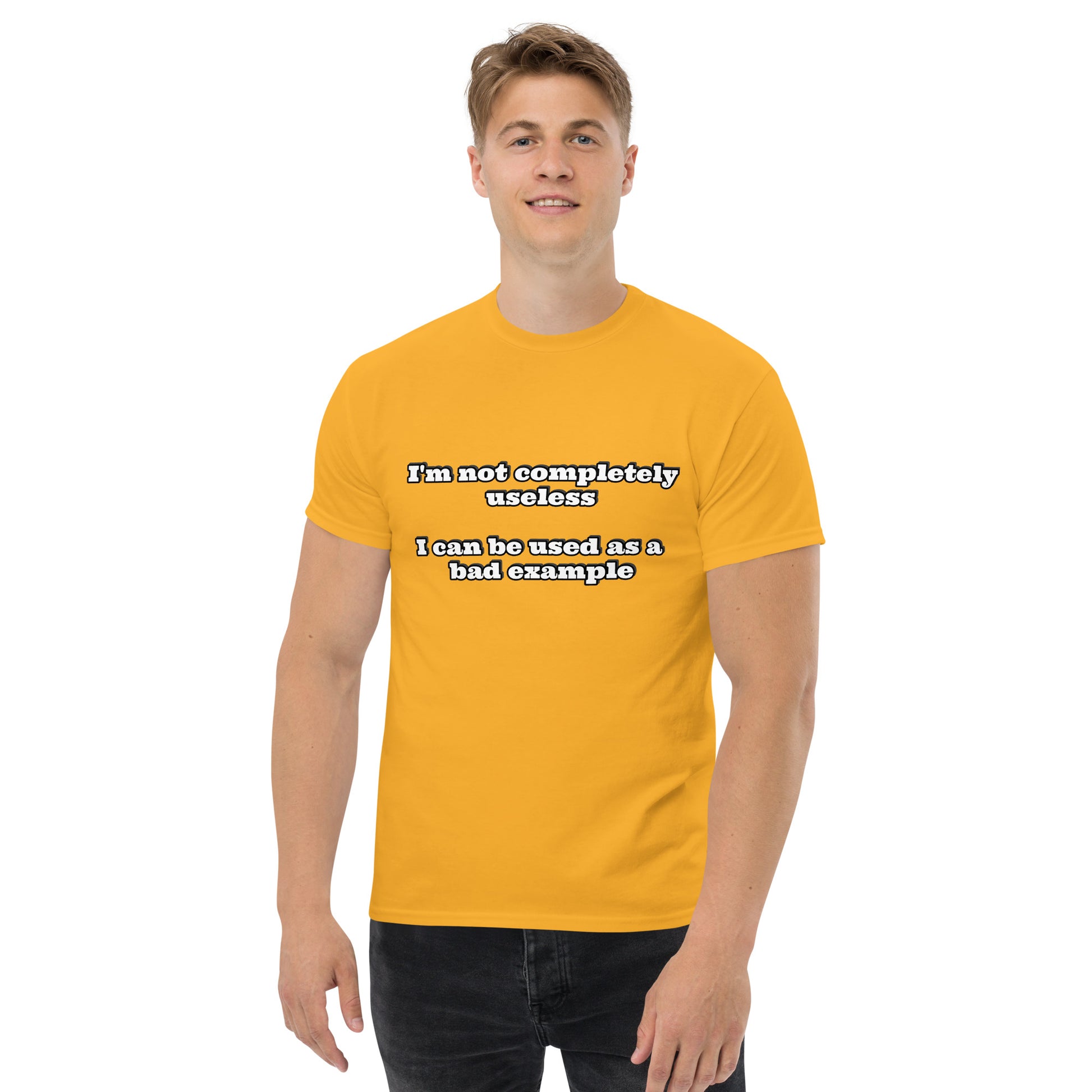 Men with gold t-shirt with text “I'm not completely useless I can be used as a bad example”