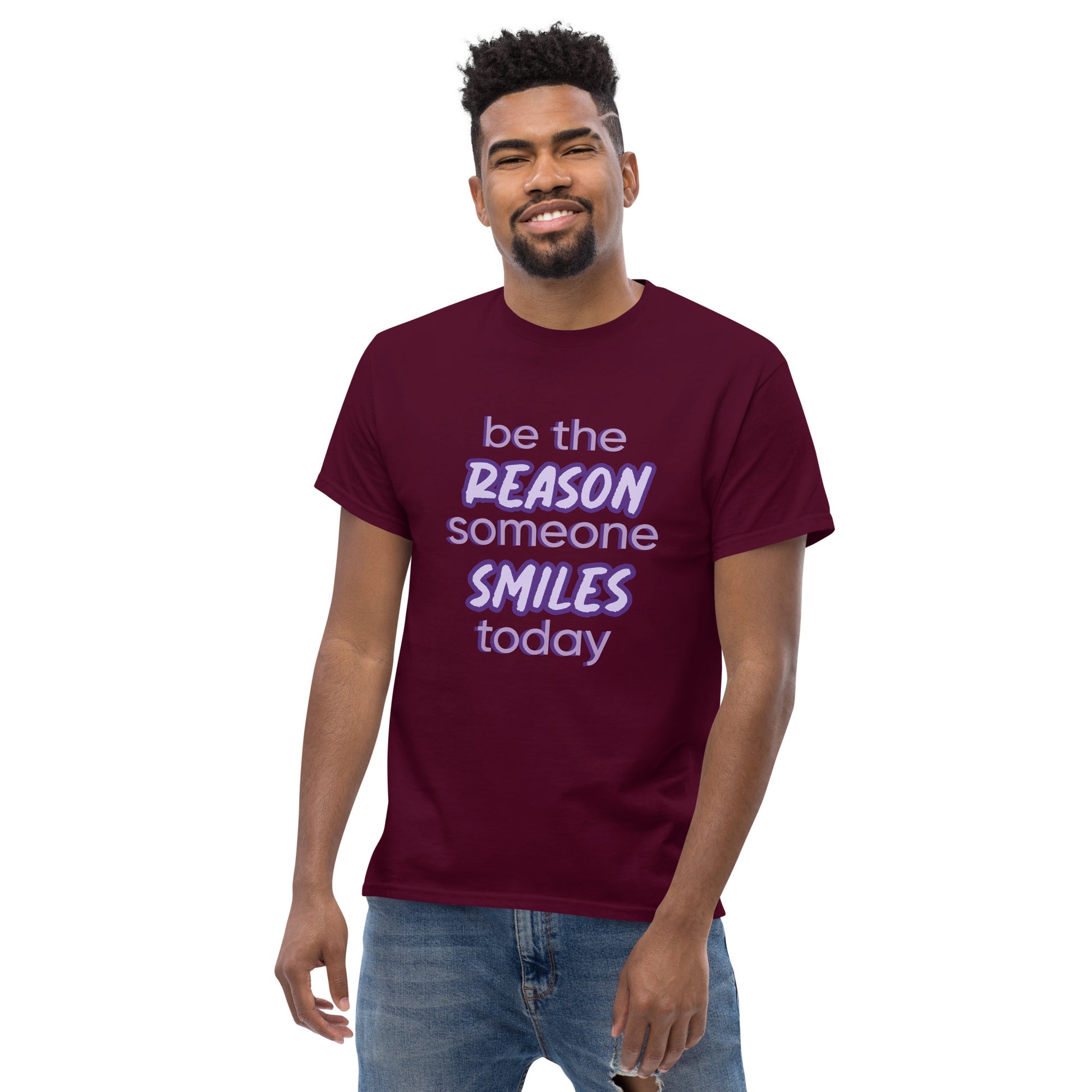 Men with maroon T-shirt and the quote "be the reason someone smiles today" in purple on it. 