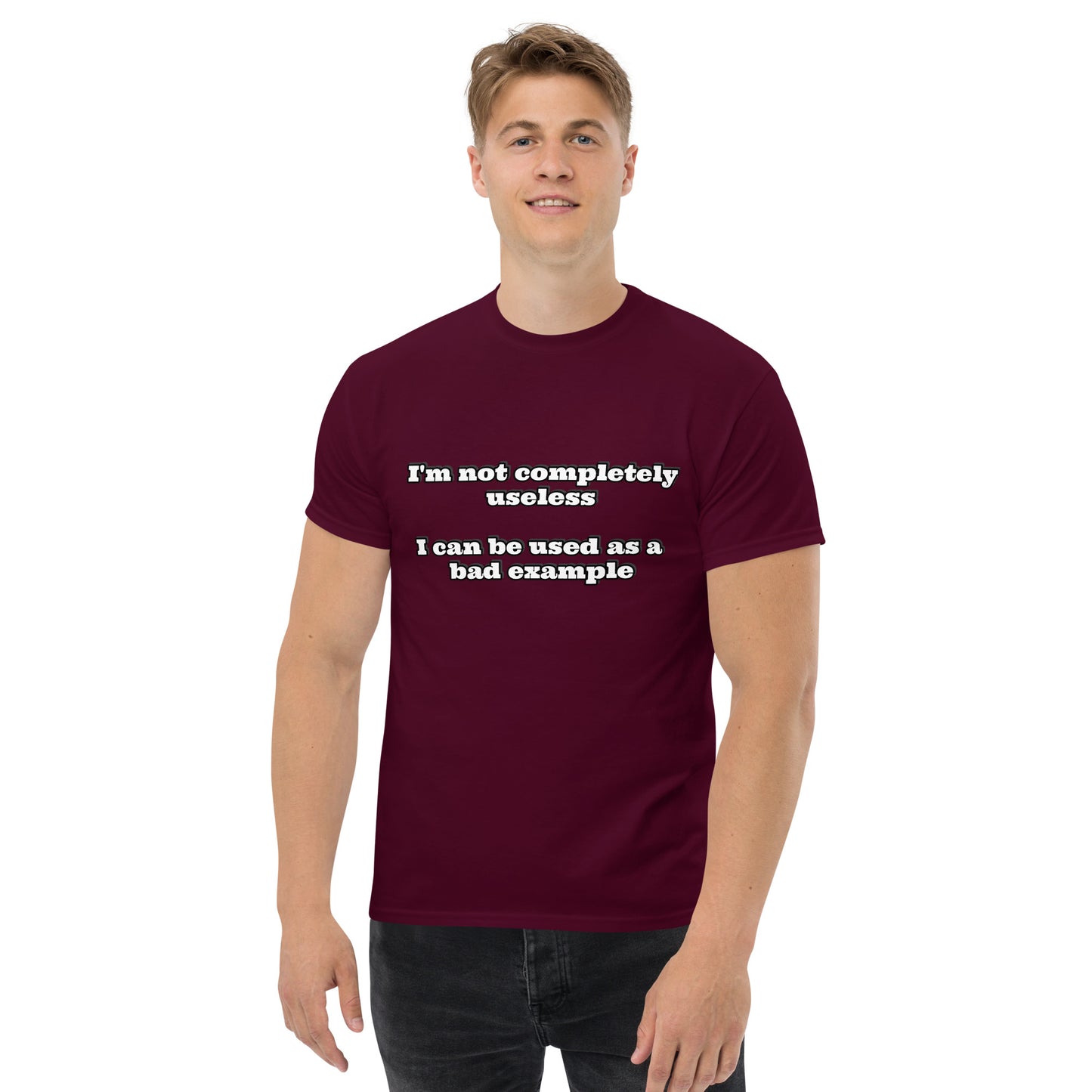 Men with maroon t-shirt with text “I'm not completely useless I can be used as a bad example”