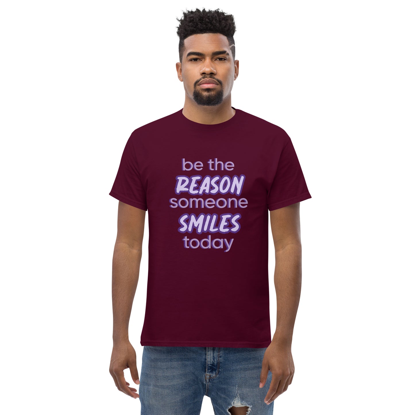 Men with maroon T-shirt and the quote "be the reason someone smiles today" in purple on it.