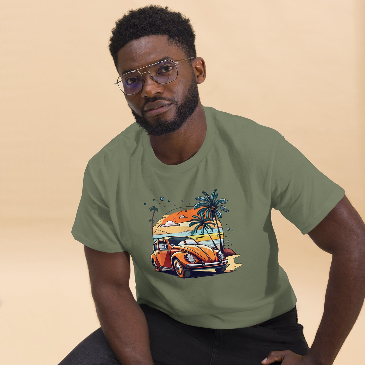 man with military green t-shirt with picture of beetle car in front of palm trees