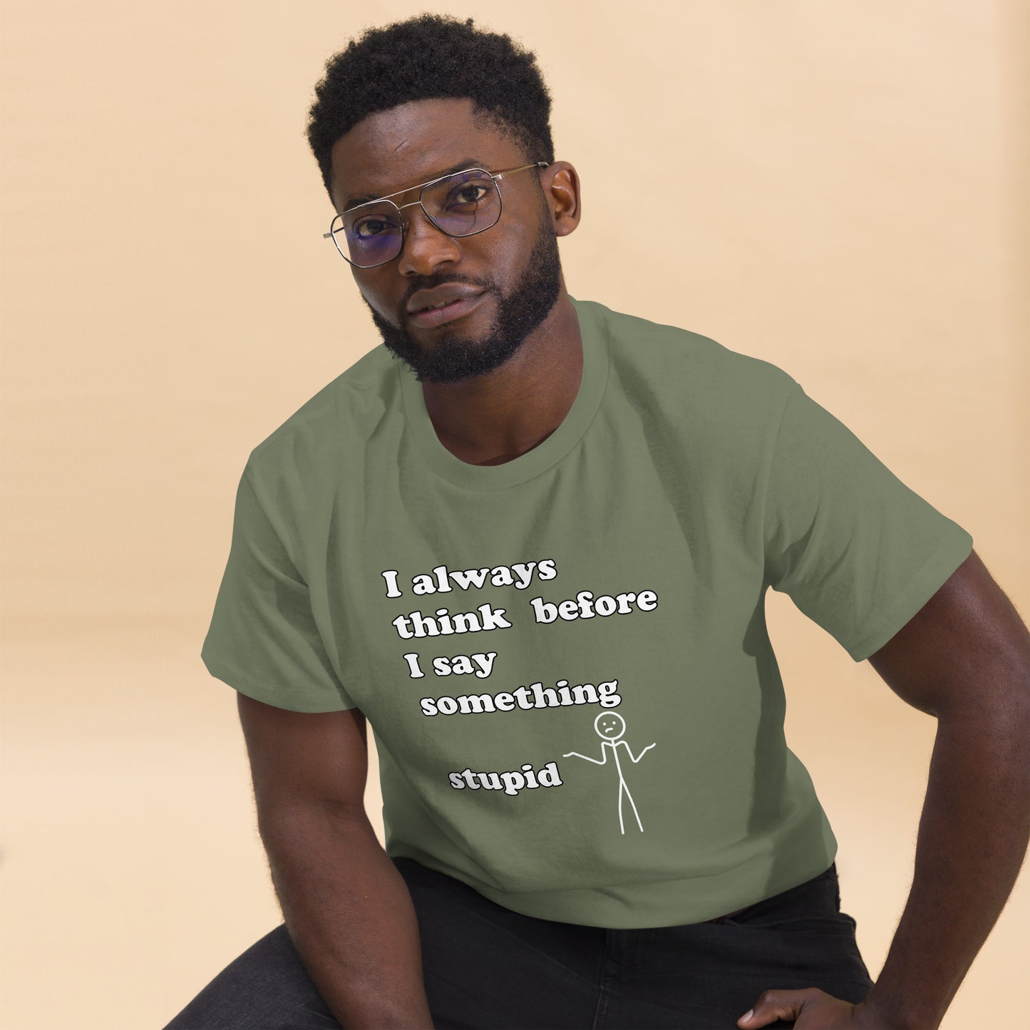 Man with military green t-shirt with text "I always think before I say something stupid"