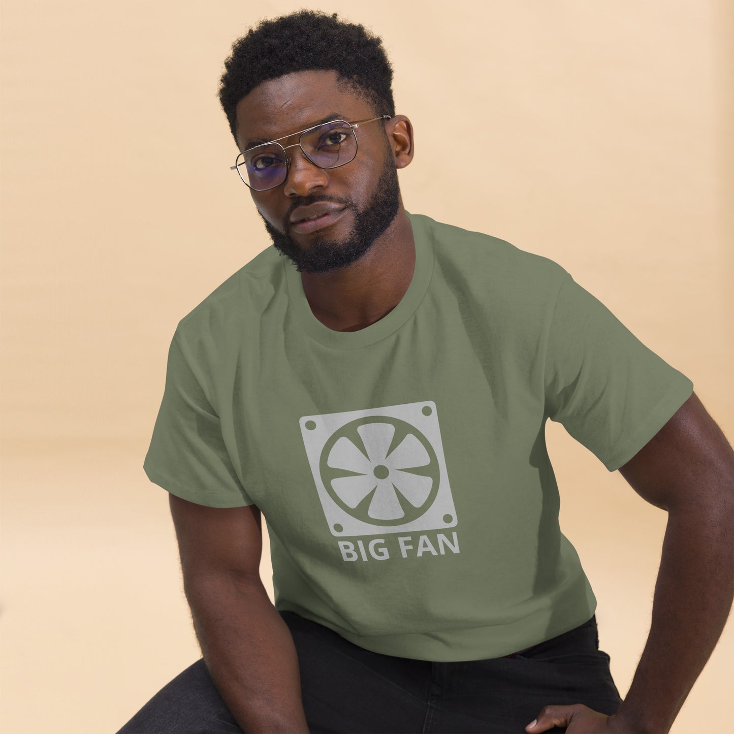 Man with military green t-shirt with image of a big computer fan and the text "BIG FAN"