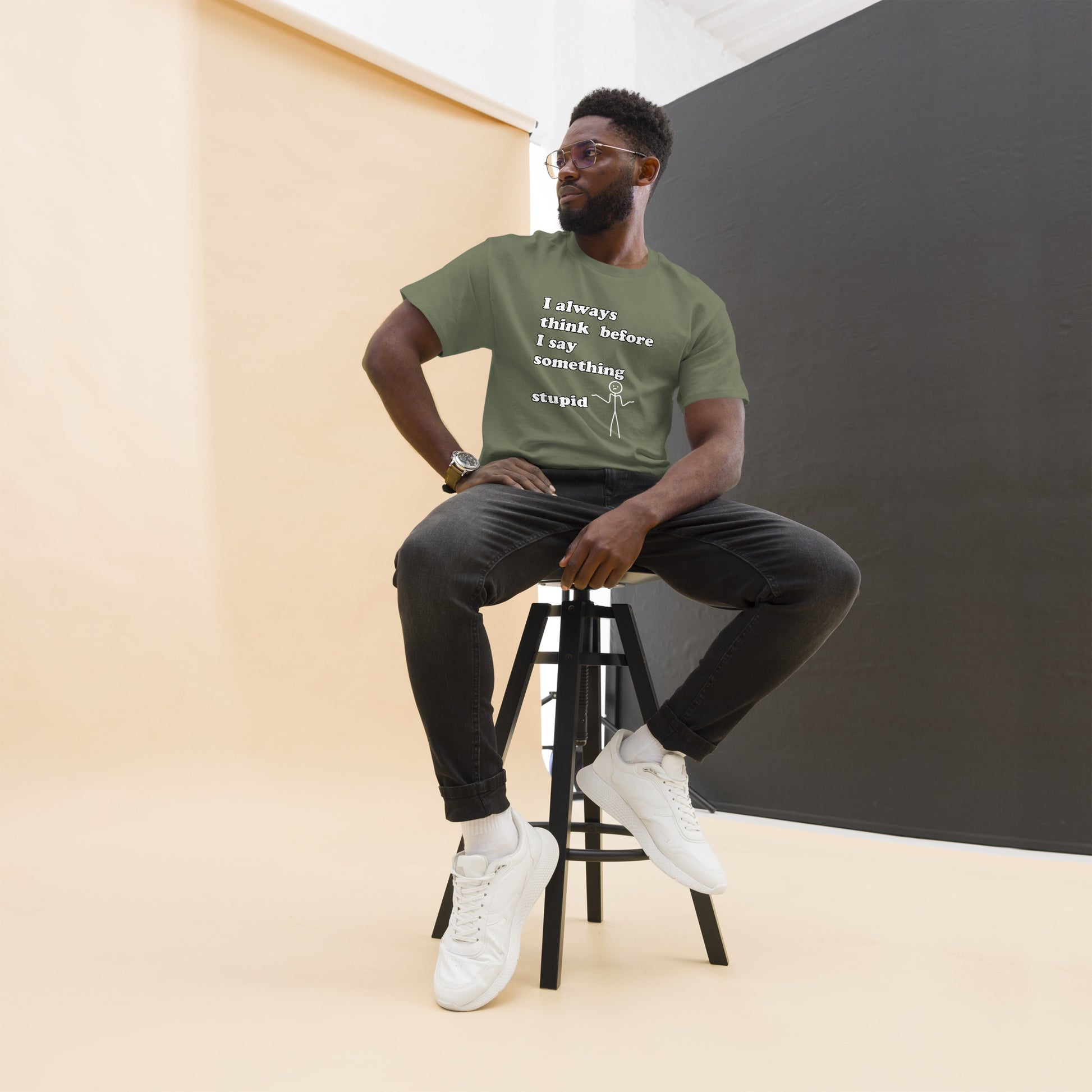 Man with military green t-shirt with text "I always think before I say something stupid"