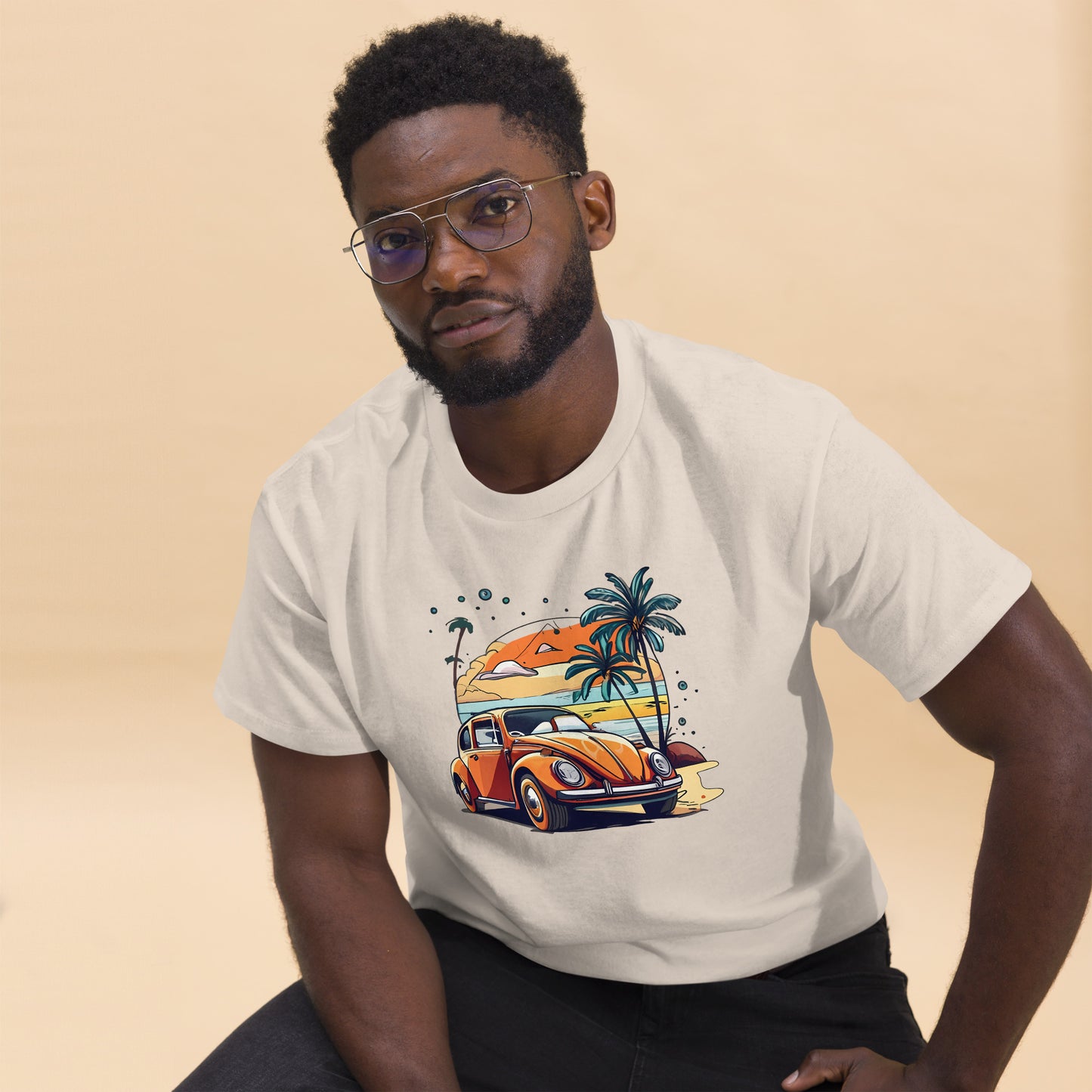man with natural t-shirt with picture of beetle car in front of palm trees