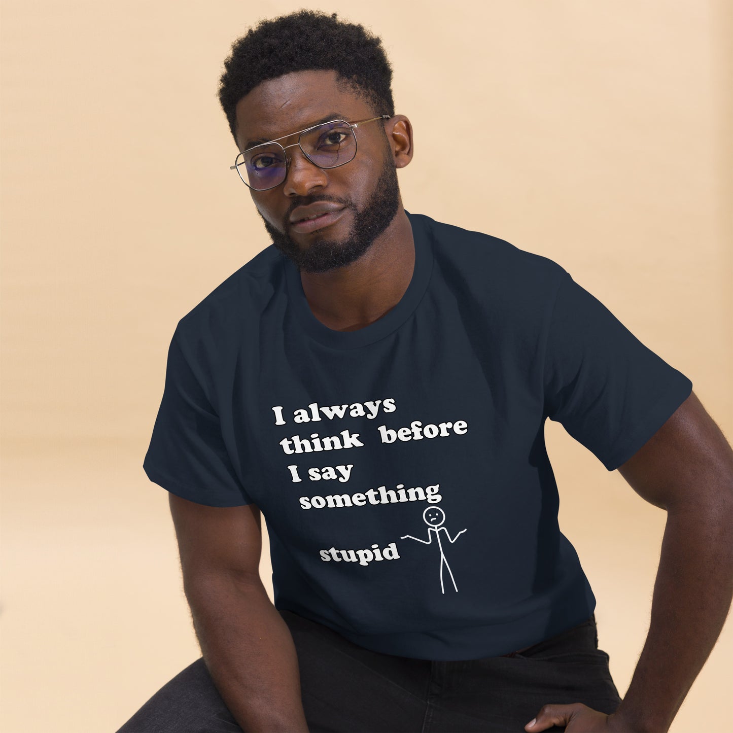 Man with navy blue t-shirt with text "I always think before I say something stupid"