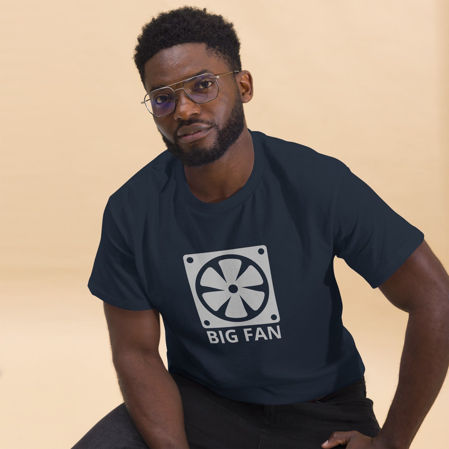 Man with dark navy blue t-shirt with image of a big computer fan and the text "BIG FAN"