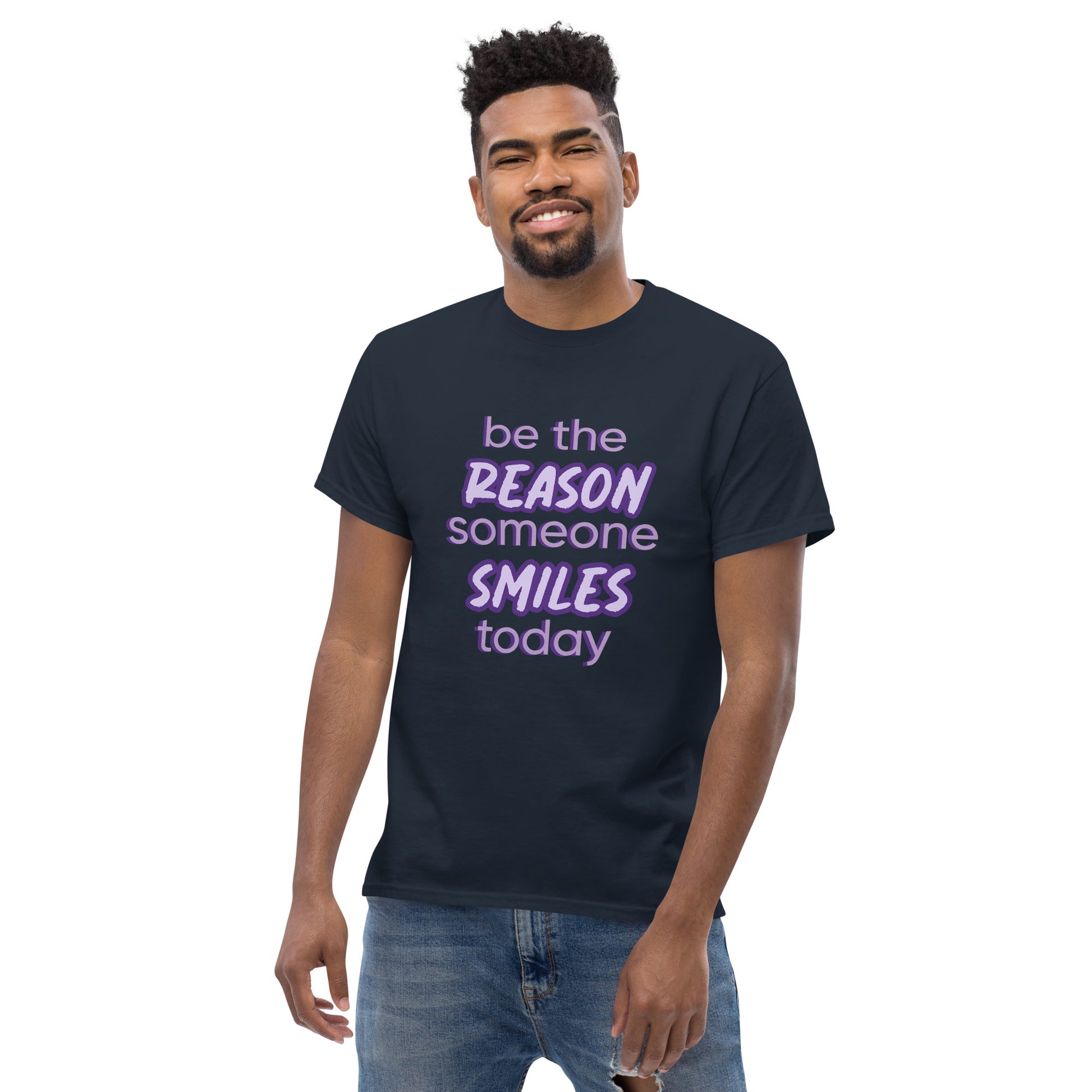 Men with navy T-shirt and the quote "be the reason someone smiles today" in purple on it. 