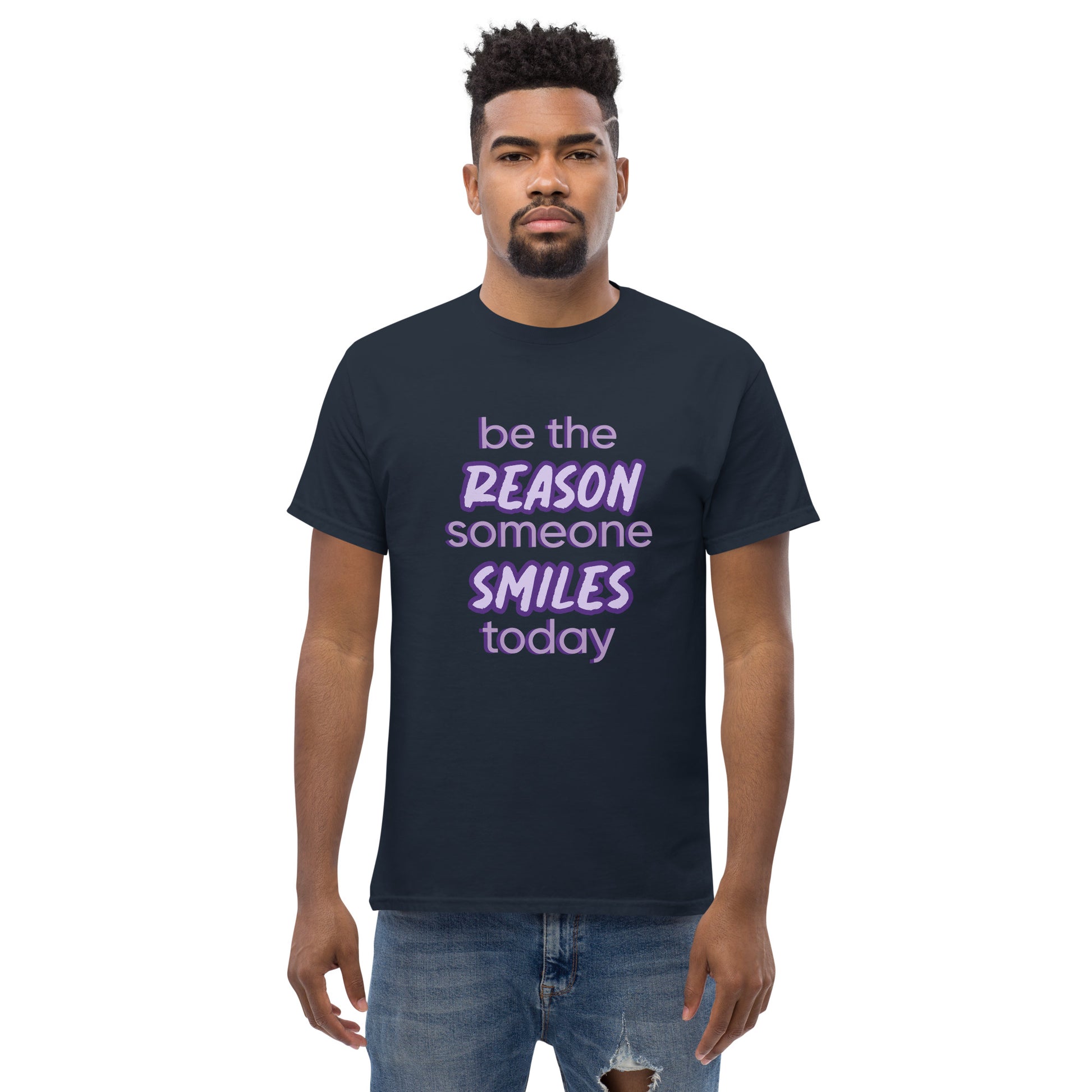 Men with navy T-shirt and the quote "be the reason someone smiles today" in purple on it. 