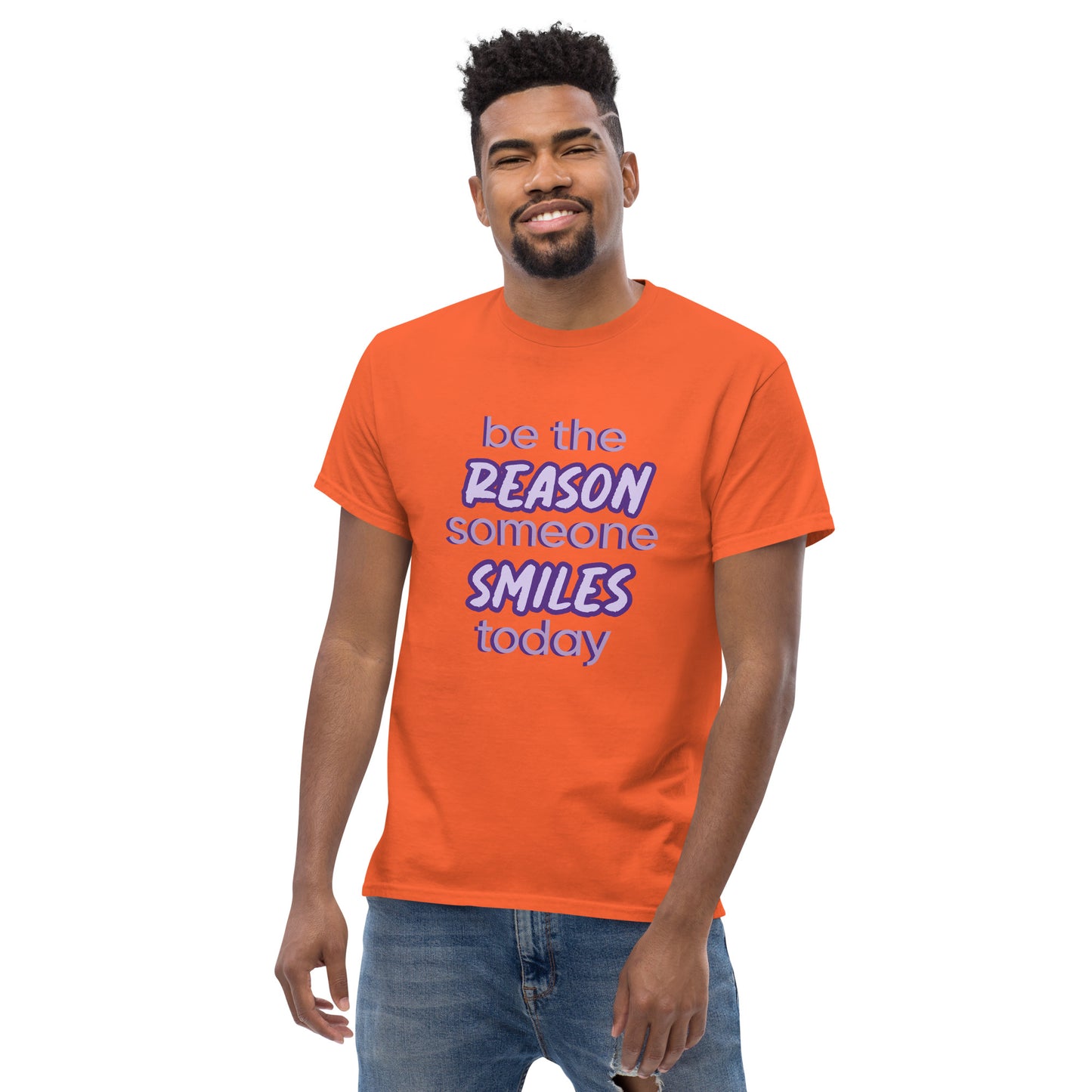 Men with orange T-shirt and the quote "be the reason someone smiles today" in purple on it.