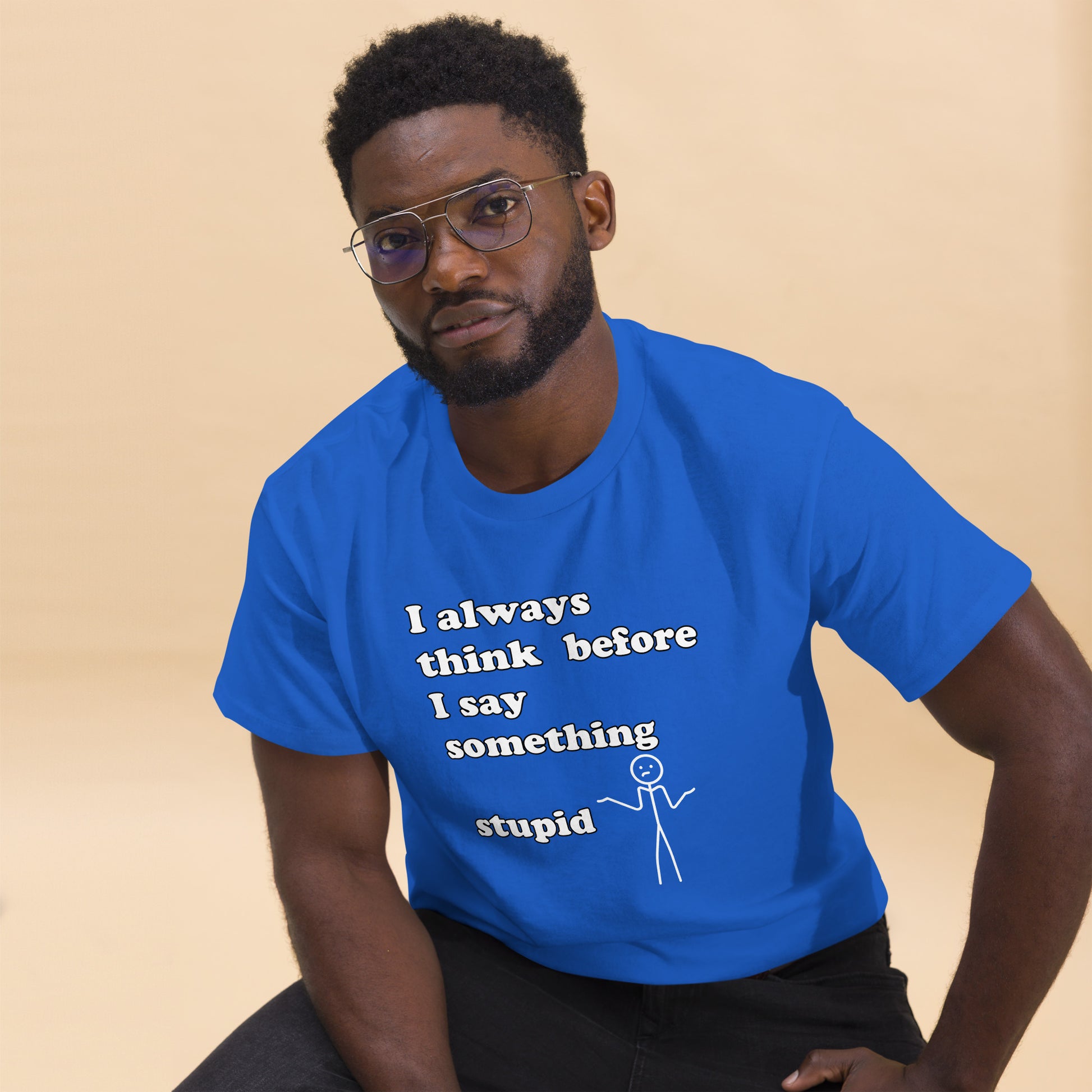 Man with royal blue t-shirt with text "I always think before I say something stupid"