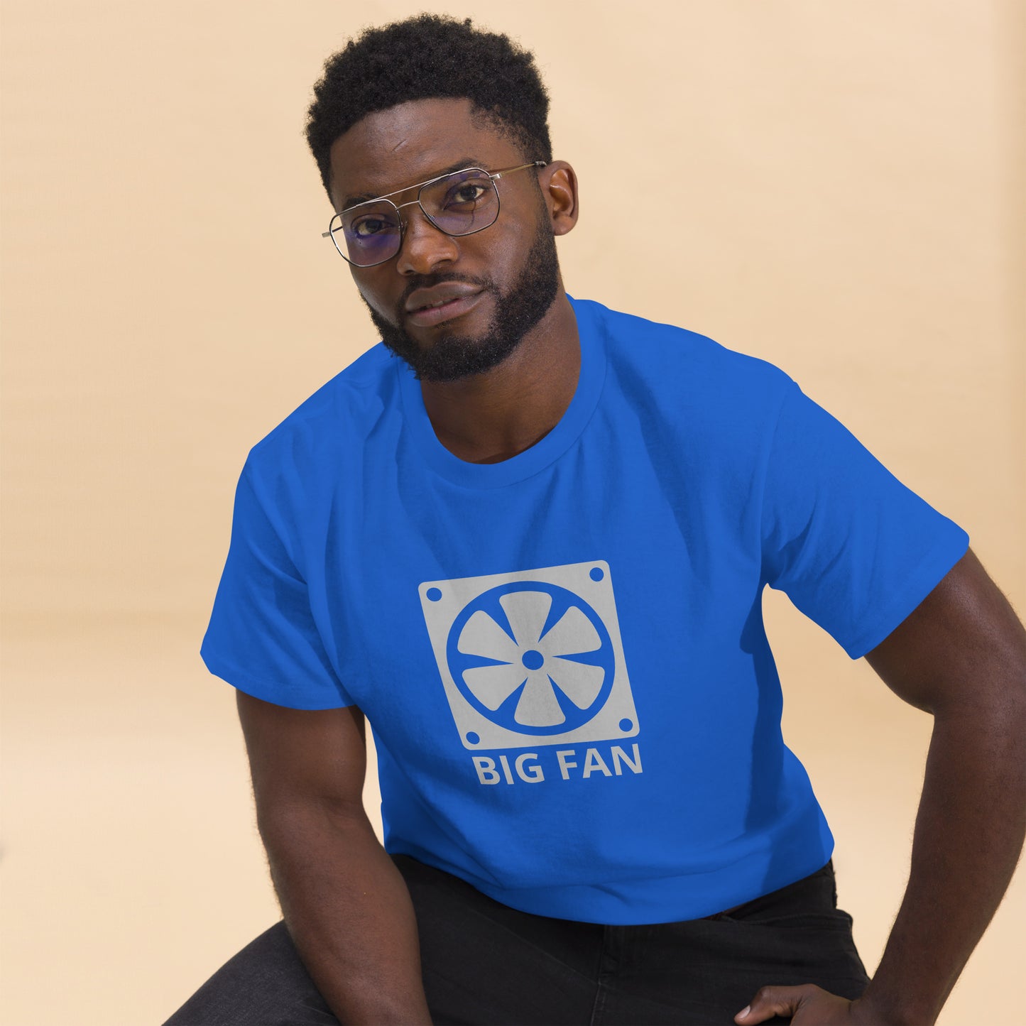 Man with royal blue t-shirt with image of a big computer fan and the text "BIG FAN"