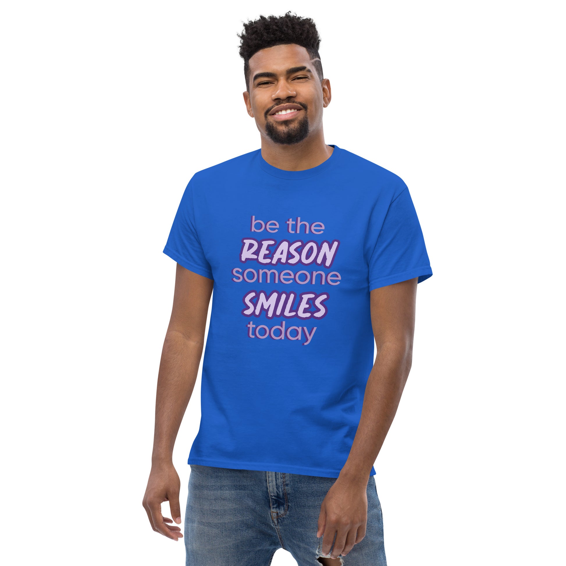 Men with royal blue T-shirt and the quote "be the reason someone smiles today" in purple on it. 
