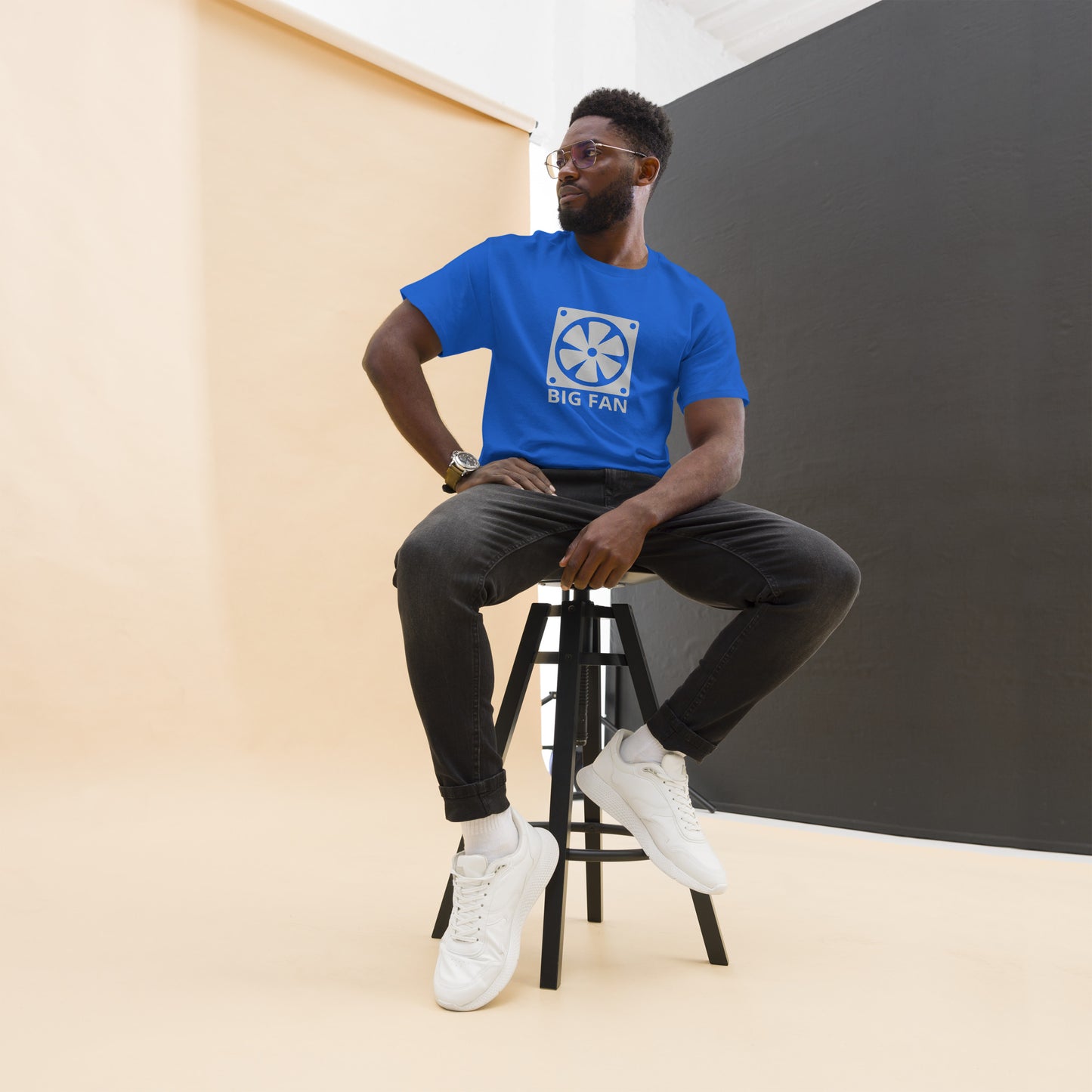Man with royal blue t-shirt with image of a big computer fan and the text "BIG FAN"