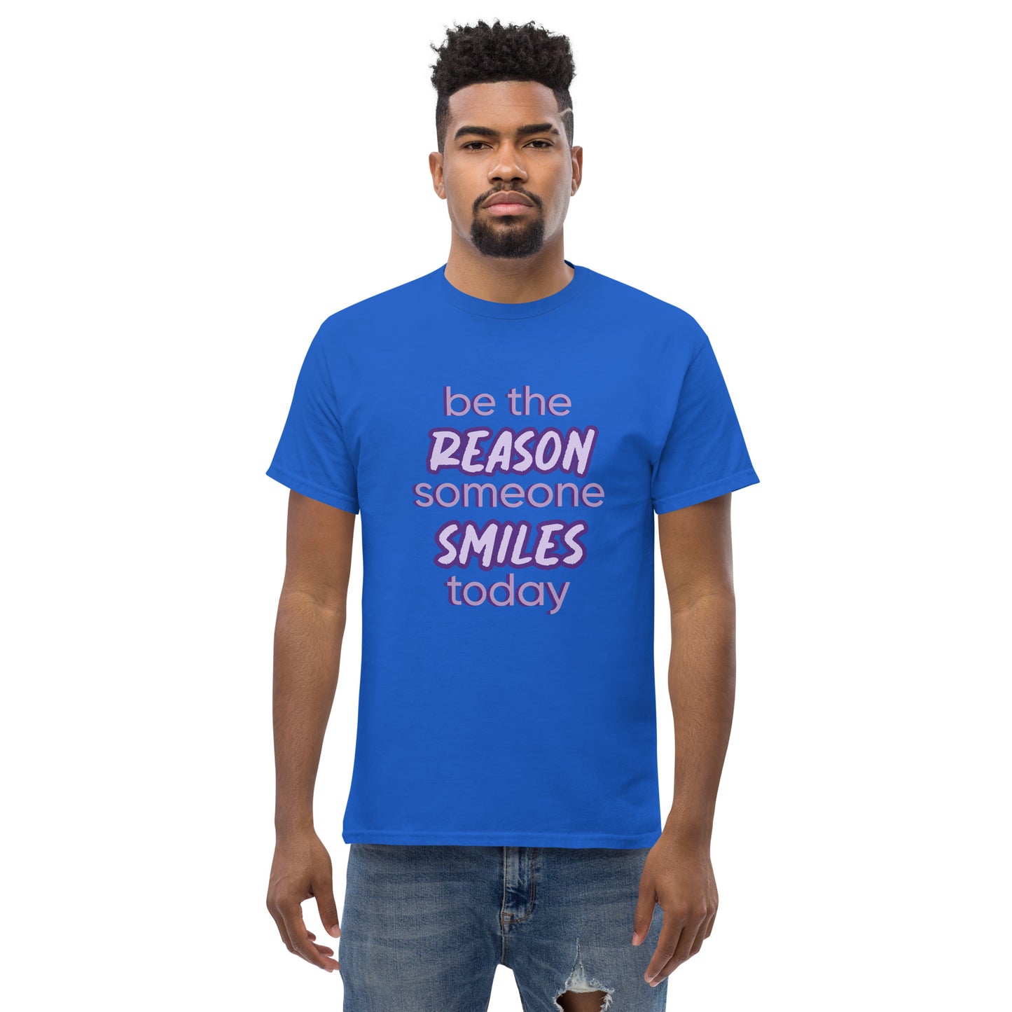 Men with royal blue T-shirt and the quote "be the reason someone smiles today" in purple on it.