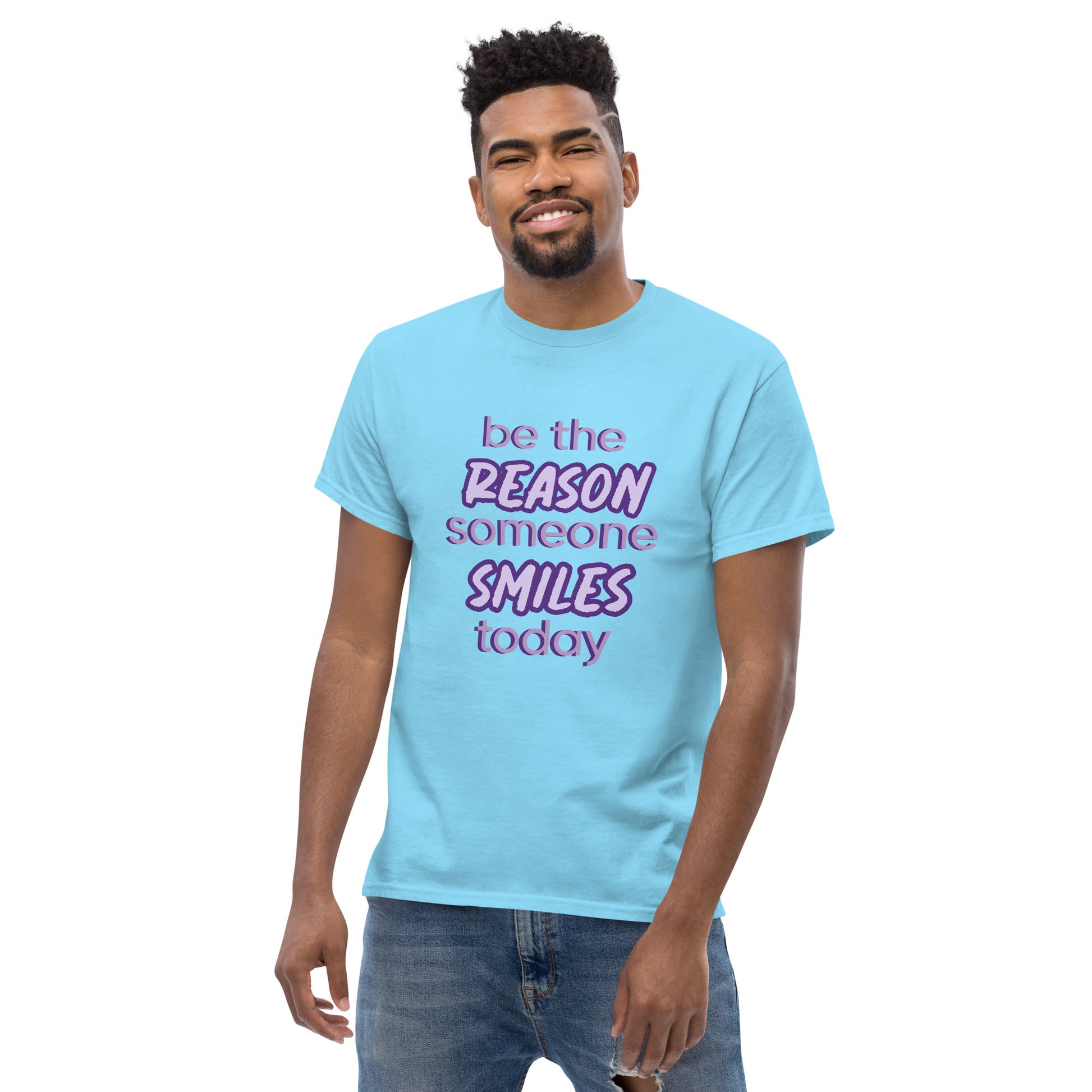 Men with sky blue T-shirt and the quote "be the reason someone smiles today" in purple on it. 