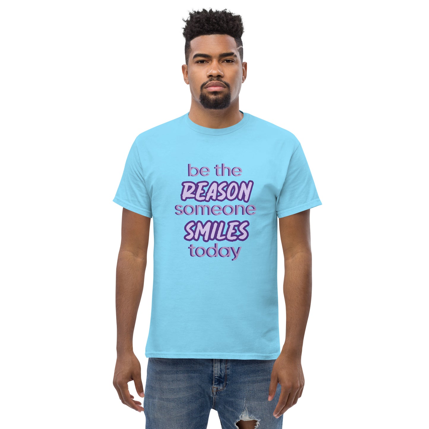 Men with sky blue T-shirt and the quote "be the reason someone smiles today" in purple on it. 