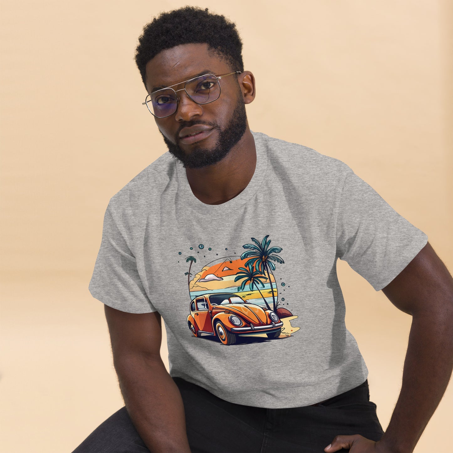 man with grey t-shirt with picture of beetle car in front of palm trees